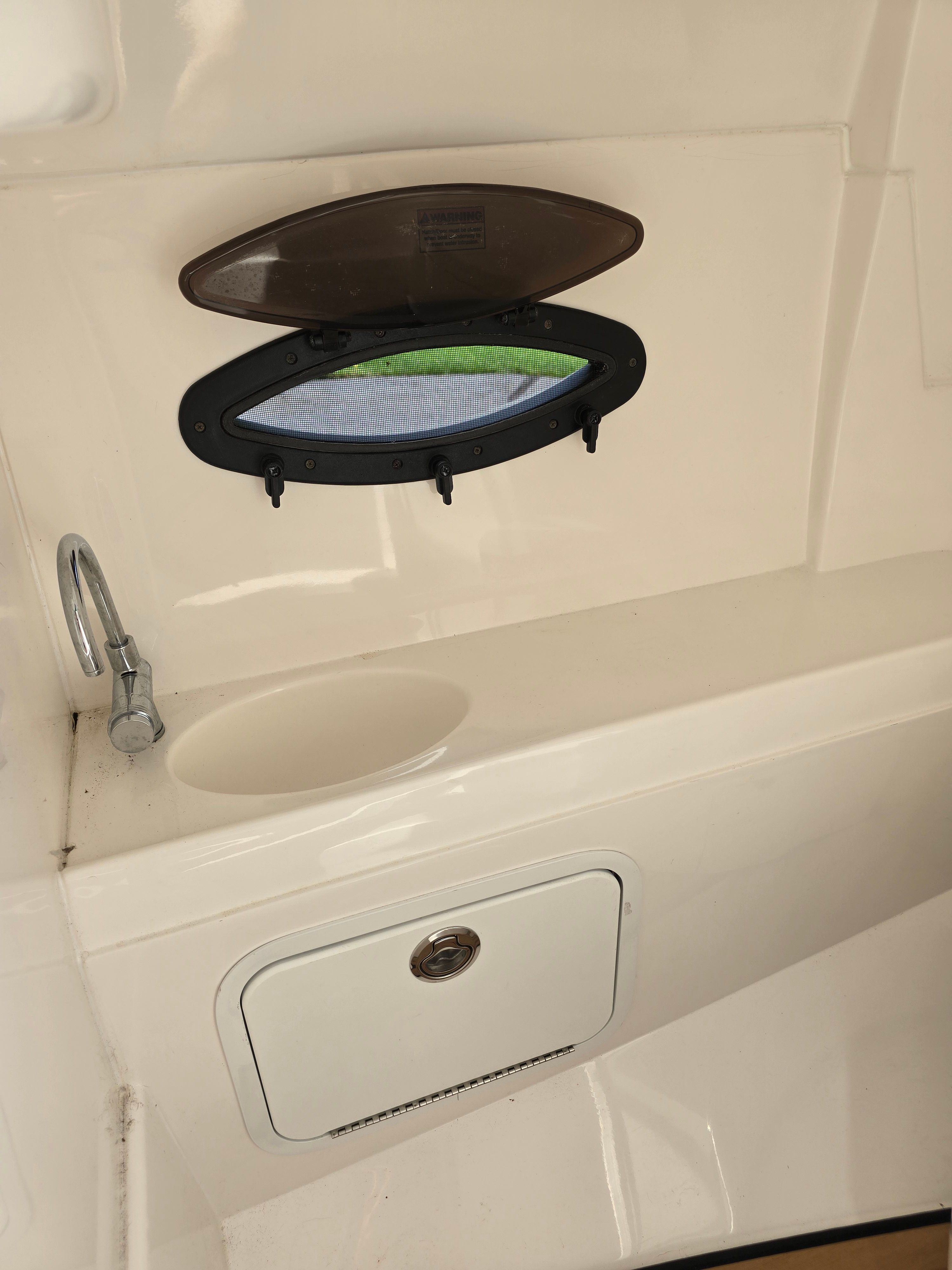 Interior of Hurricane SD 2200 boat, showing window and sink.