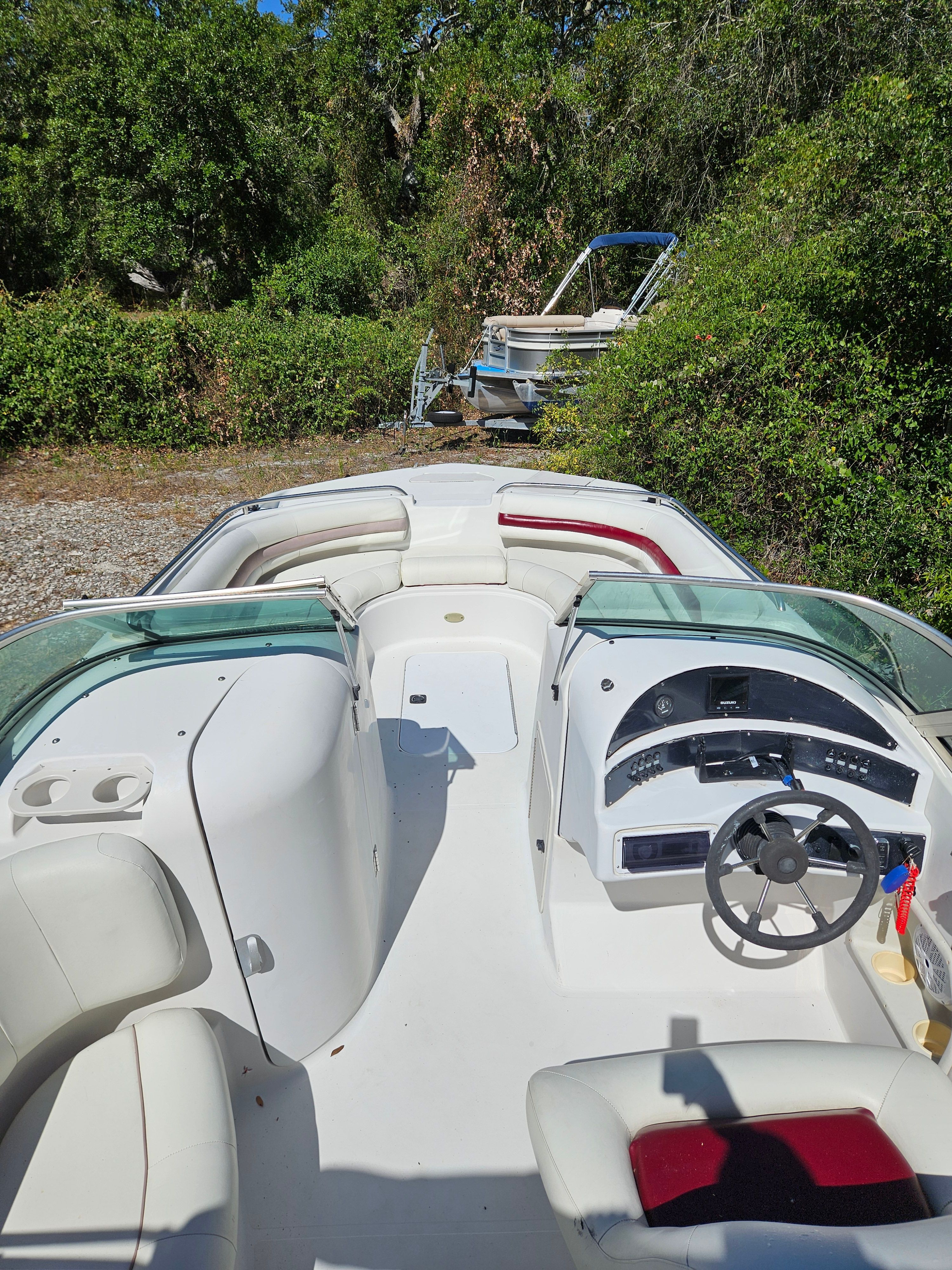 The image shows a 2001 Hurricane 237 boat with an open cockpit and a helm station.