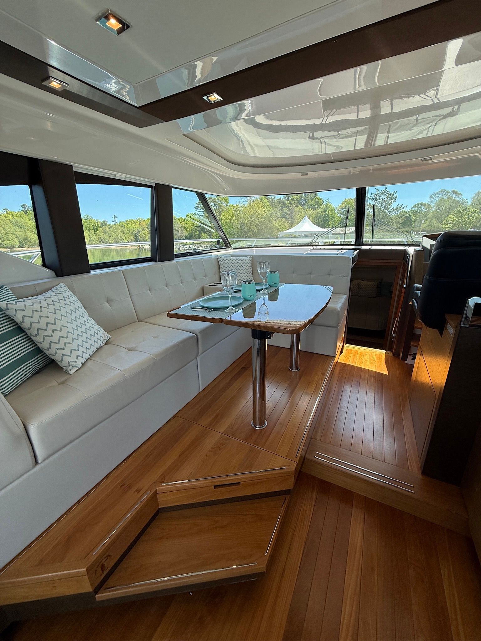 Interior of a 2017 Tiara Yachts C44 Coupe with elegant seating area and wooden flooring.