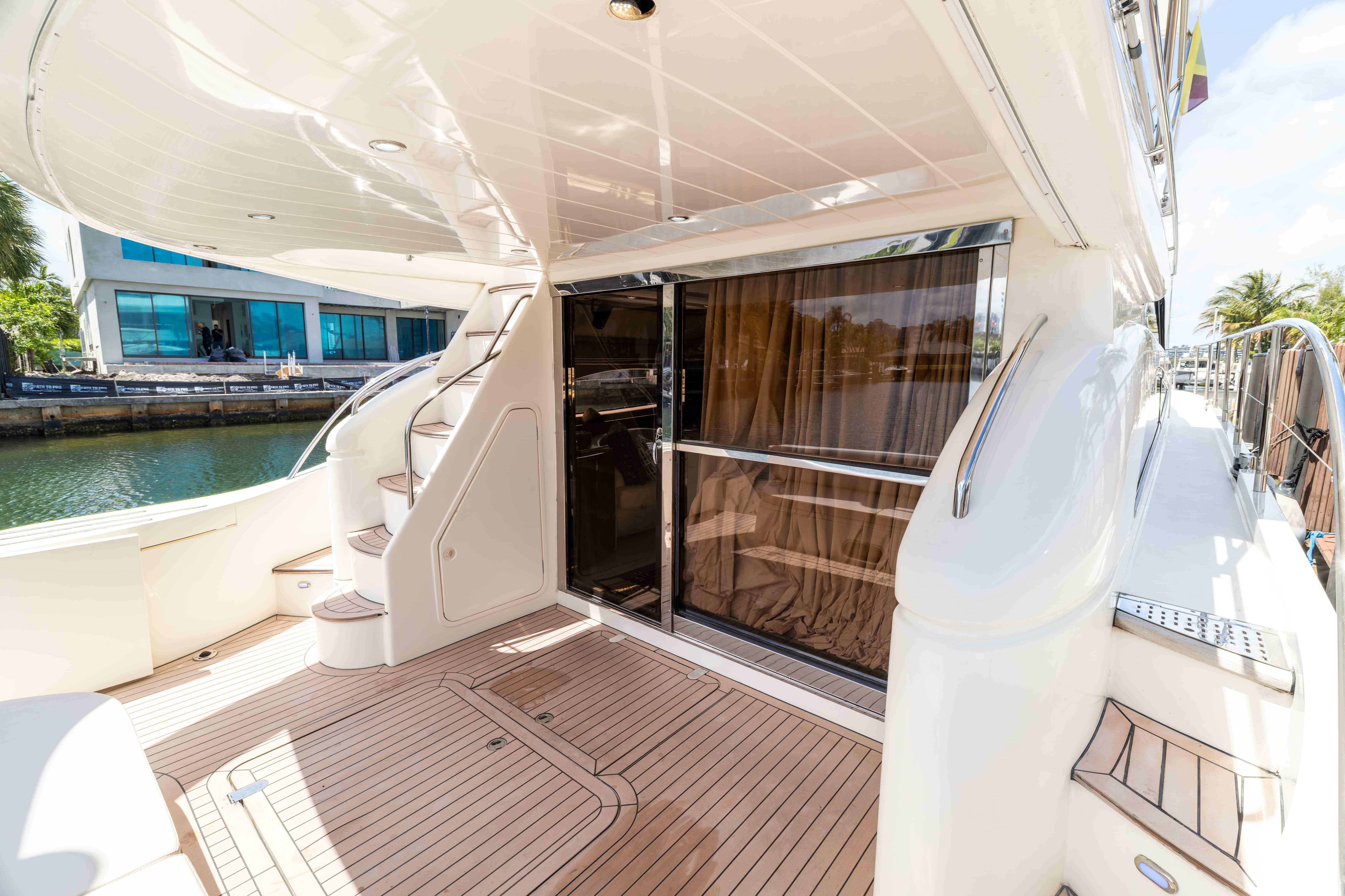 Luxurious 2002 Princess 61 yacht deck with elegant wood flooring and sleek design.