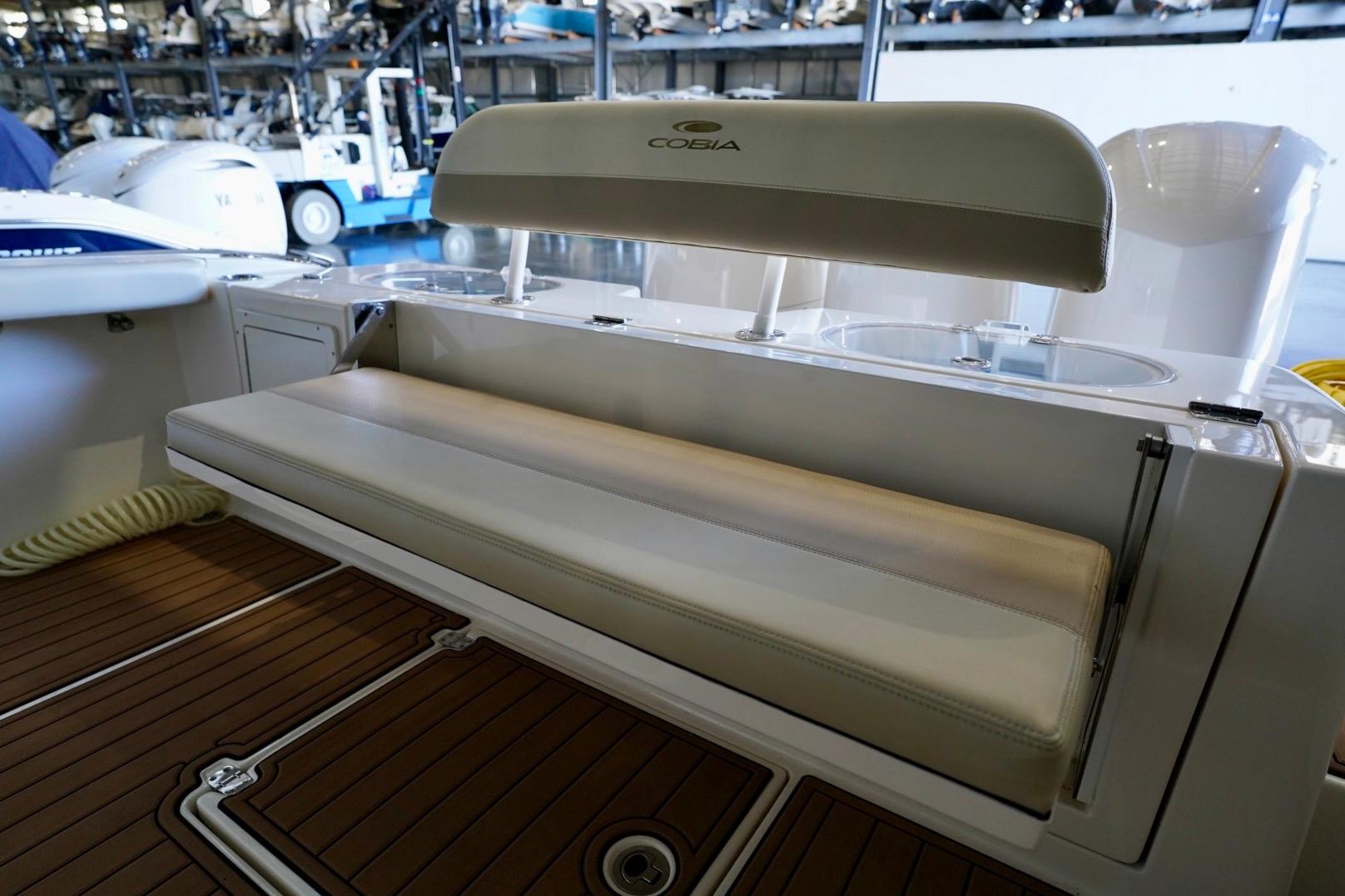2019 Cobia 344 Center Console boat interior with cushioned seating and wooden deck.