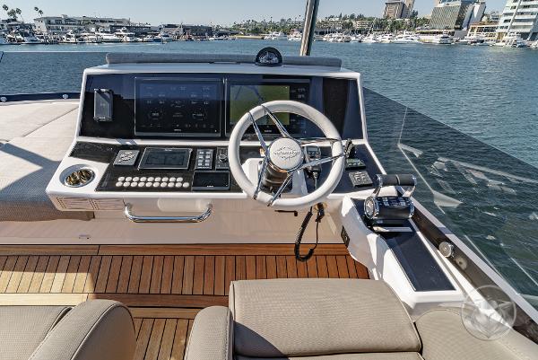 2025 Sunseeker Manhattan 68 yacht helm with modern controls and waterfront view.
