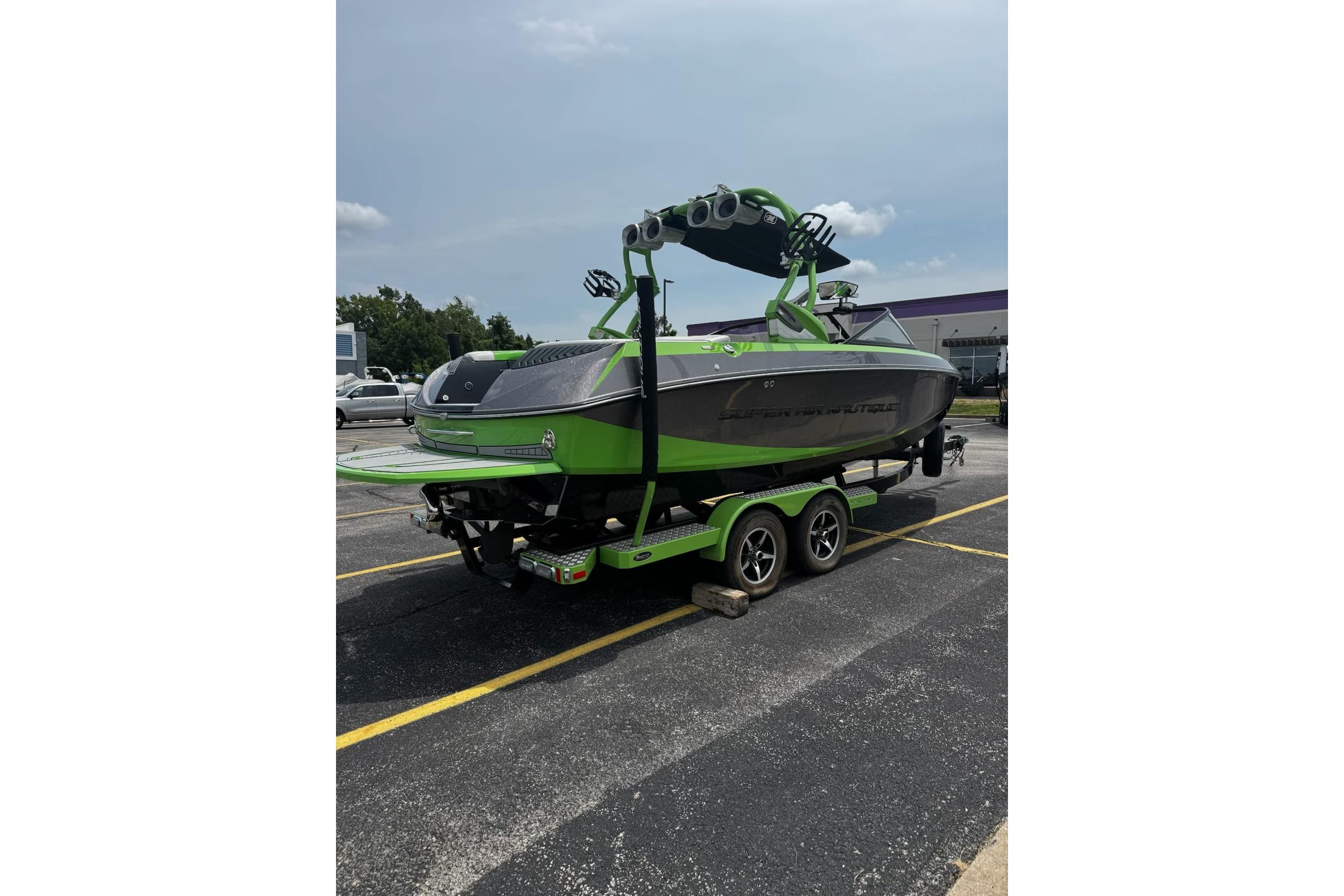 2014 Nautique Super Air Nautique G21 boat on trailer, vibrant green and gray design.