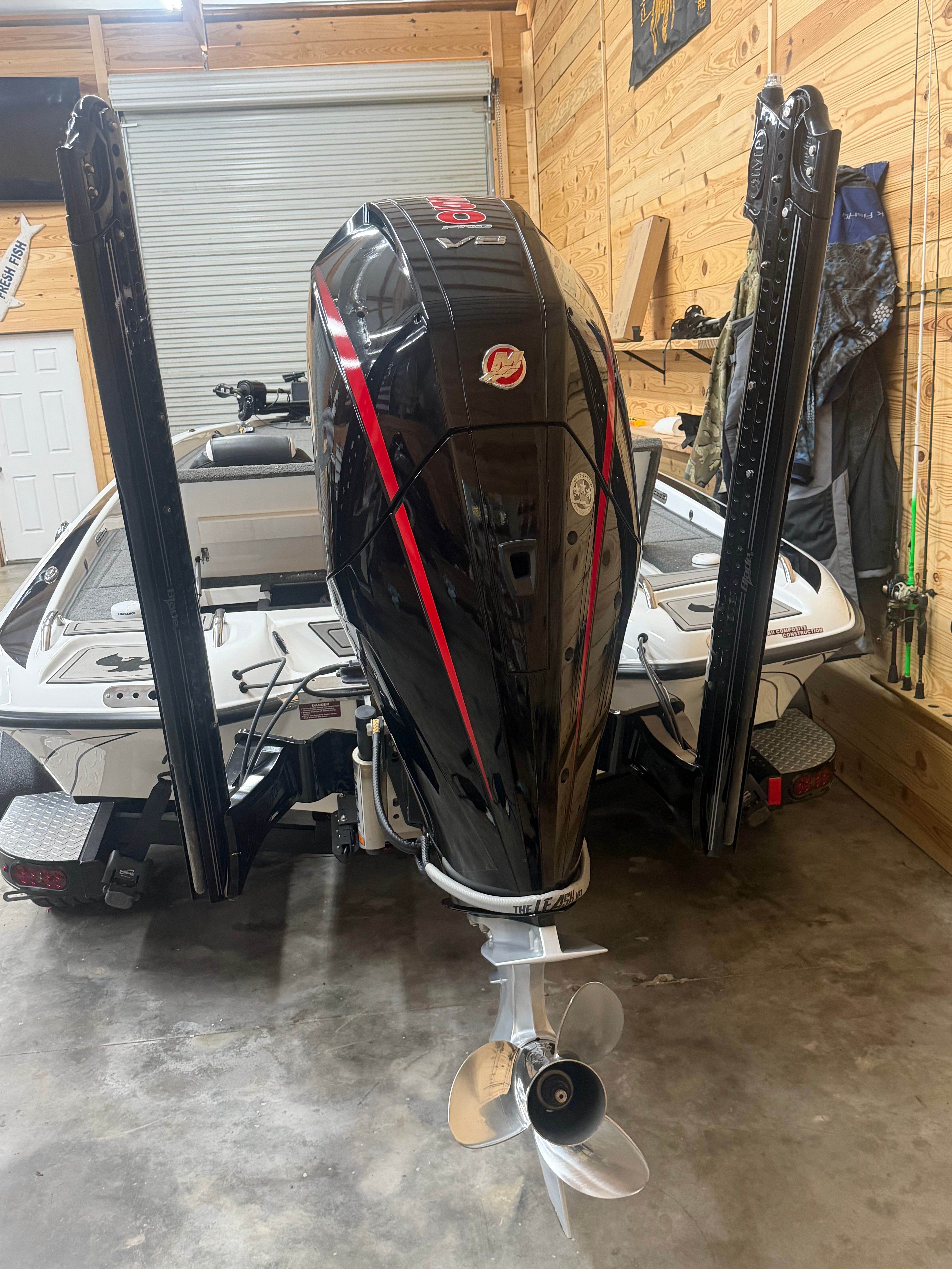 A 2024 Phoenix 920 Elite in a garage. The outboard motor is prominently visible.