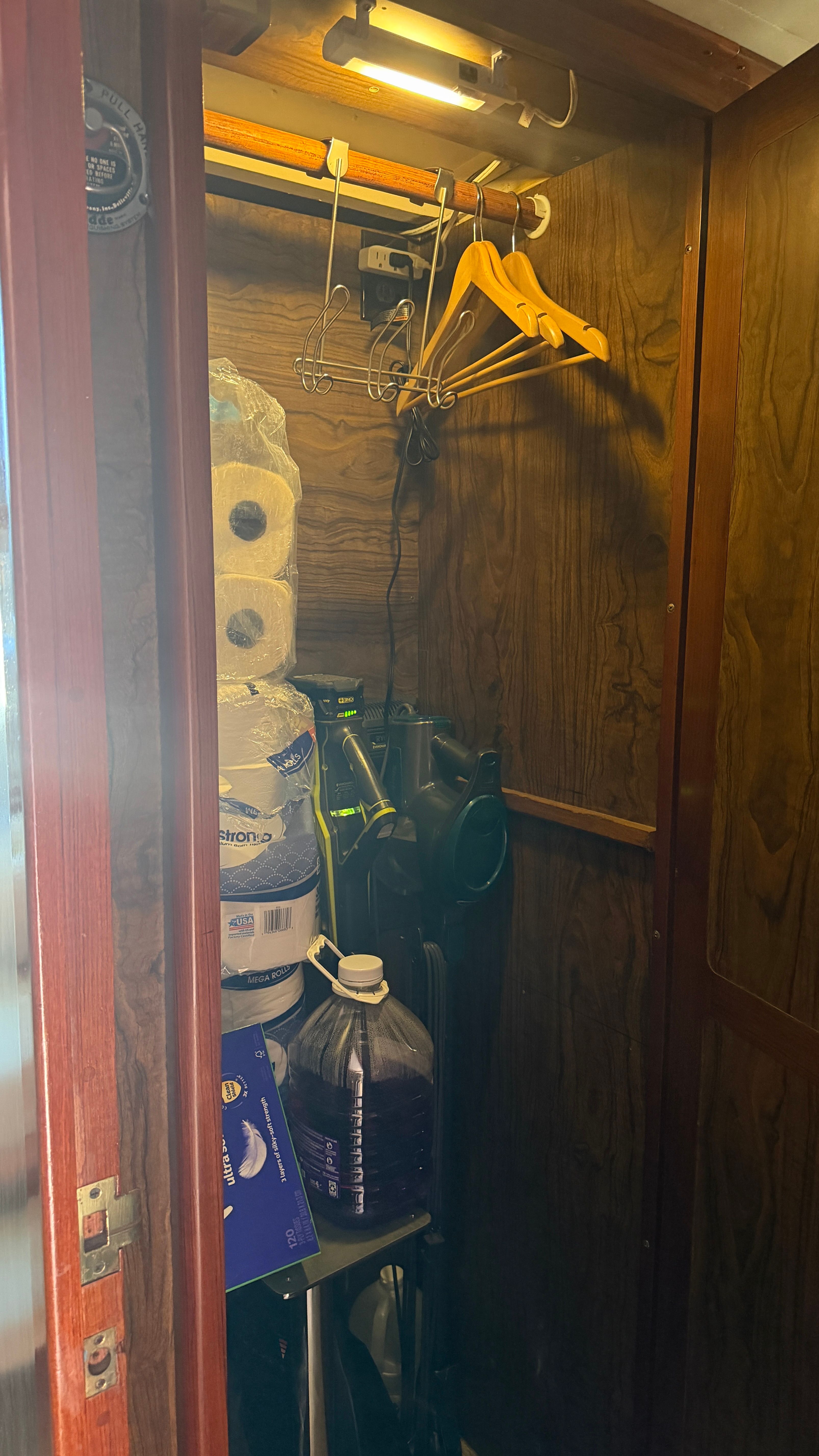 Storage closet in a 1966 Drake Yachtfisher with supplies.