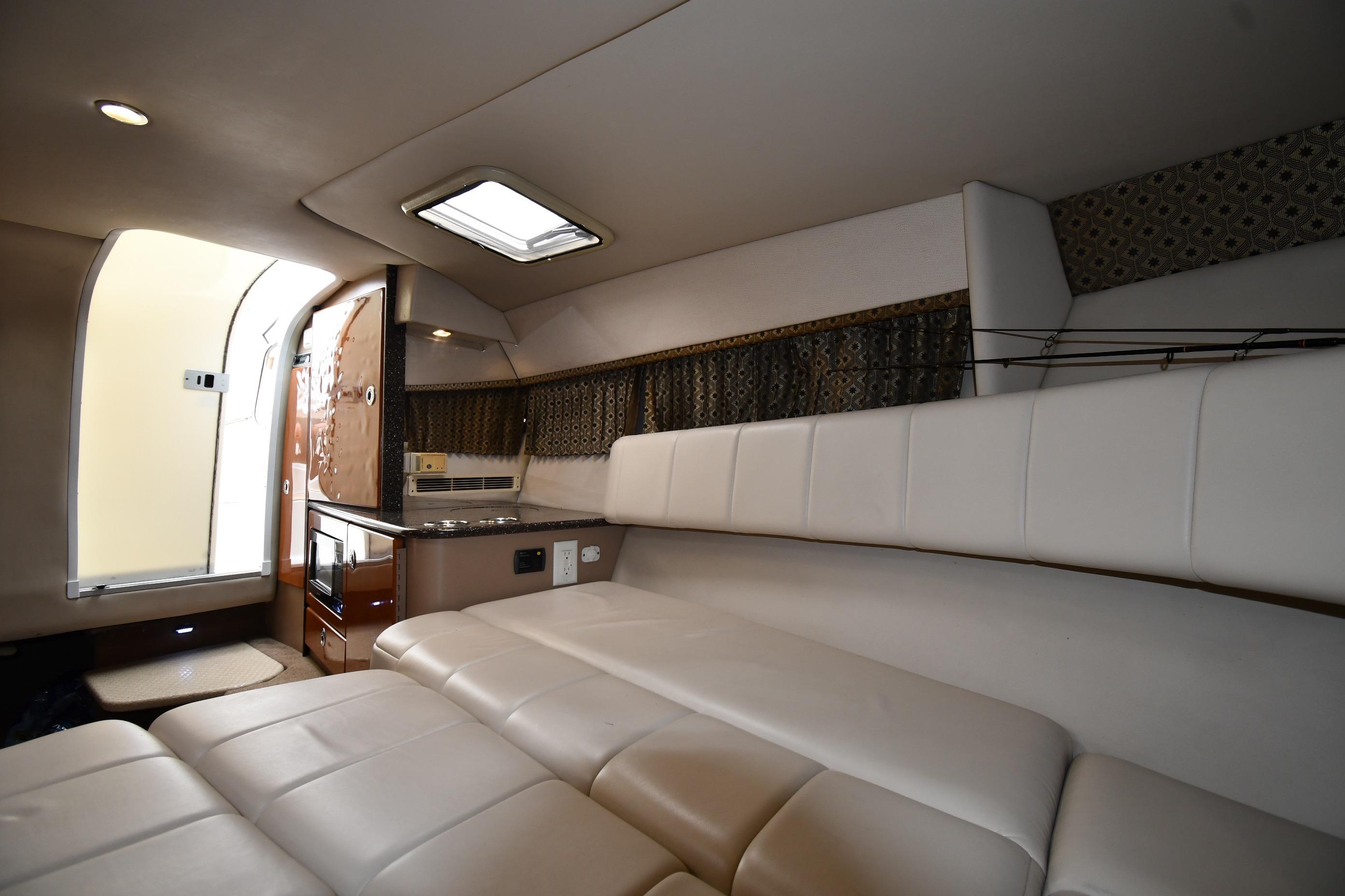 Interior of 2004 Formula 330 Sun Sport boat with white seating and kitchenette.