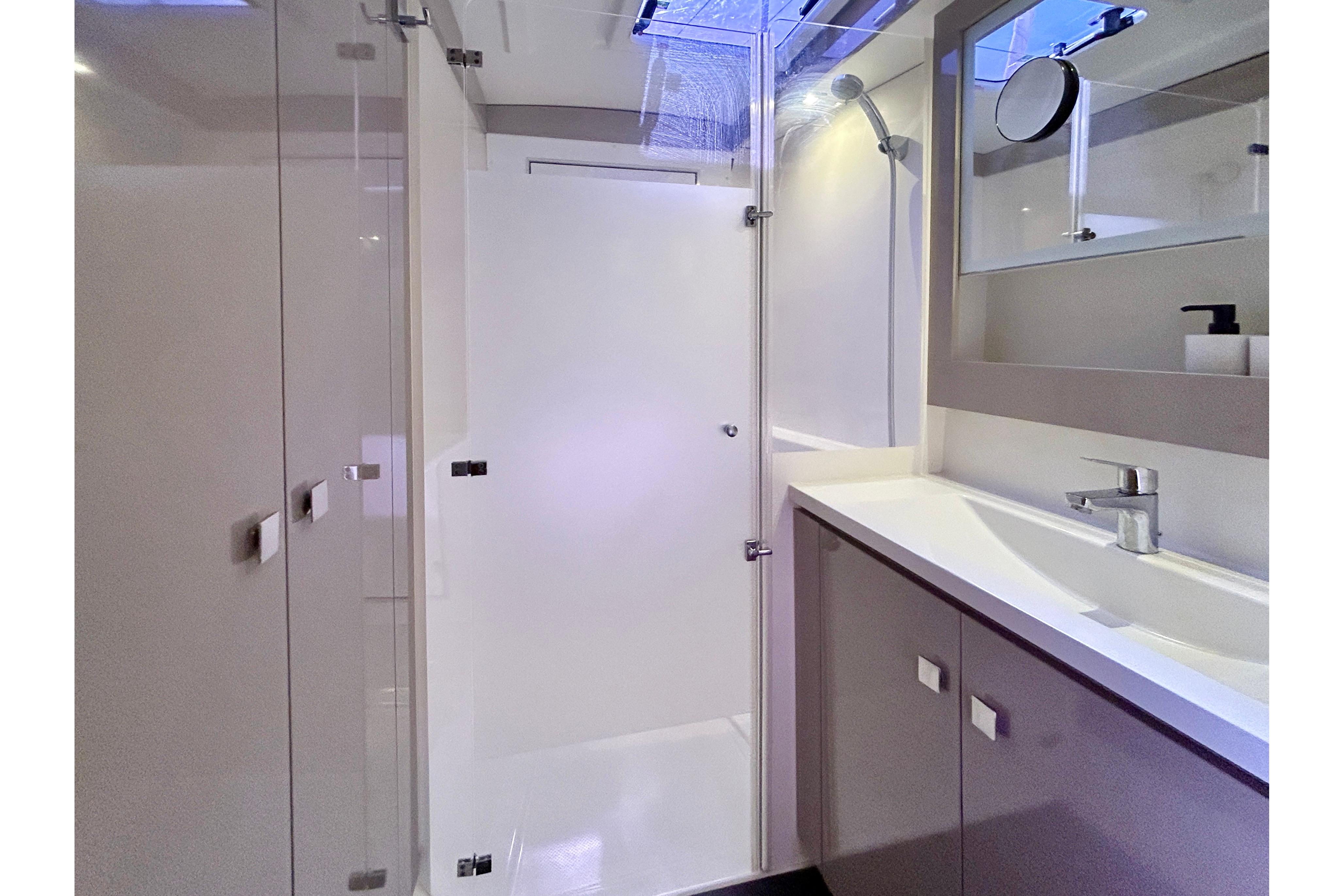 Modern bathroom interior of 2021 Fountaine Pajot Isla 40 yacht, featuring sleek design and fixtures.