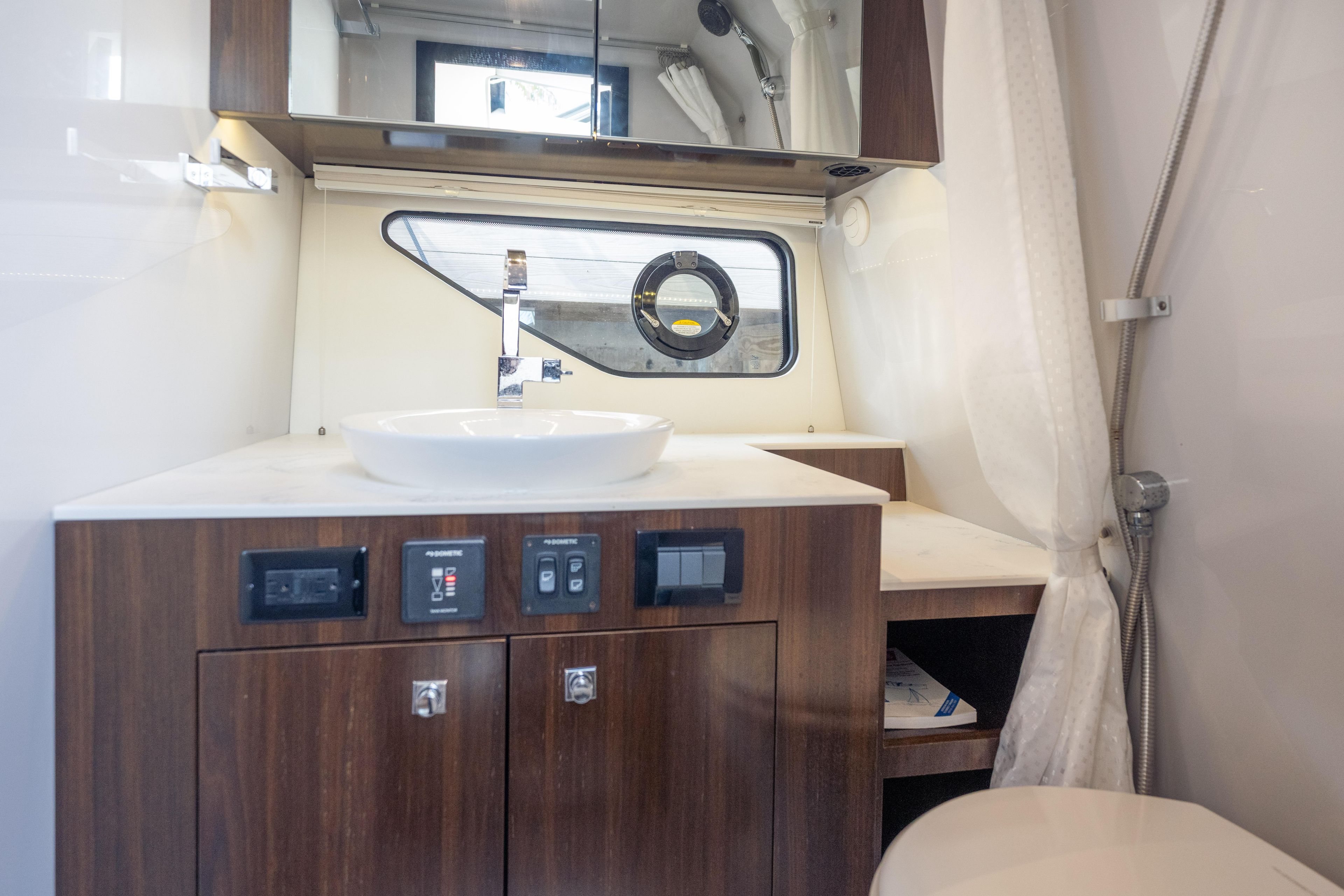 2021 Cruisers Yachts 38 GLS bathroom with modern sink and wood cabinetry.