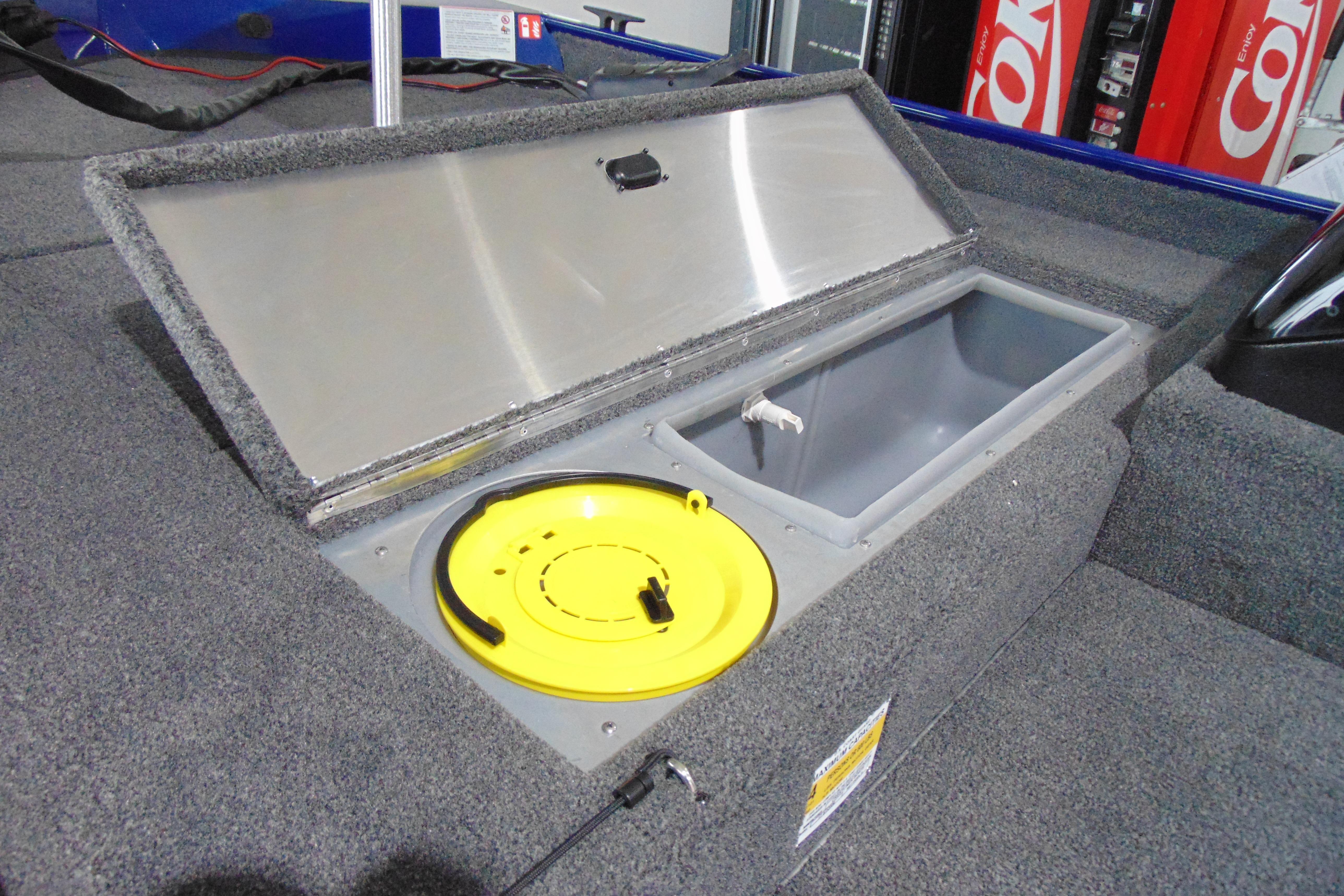 Open storage compartment in 2026 Crestliner 1700 Storm boat, featuring a yellow lid.