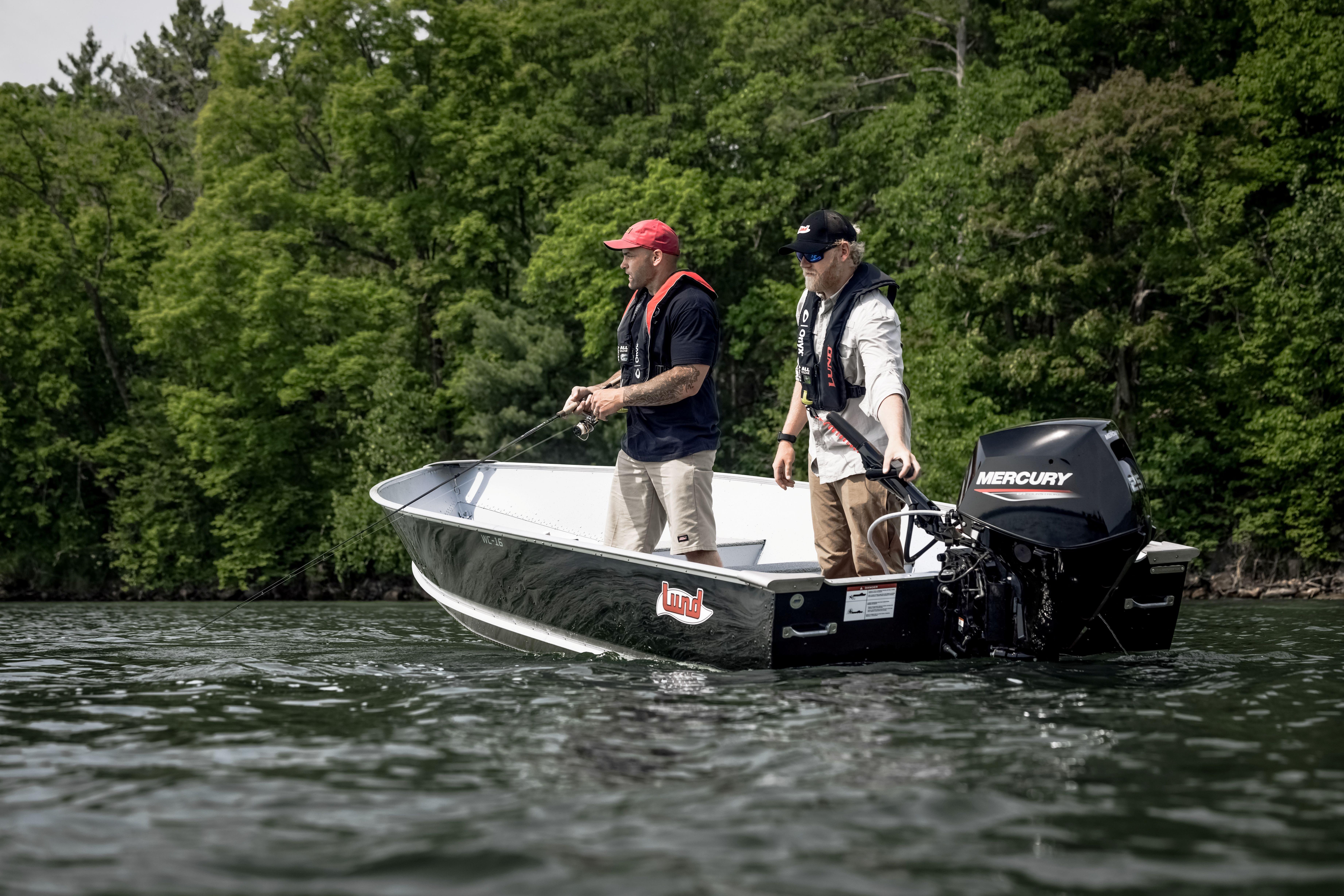 Two people fishing on a 2027 Lund WC 16 boat with Mercury engine.