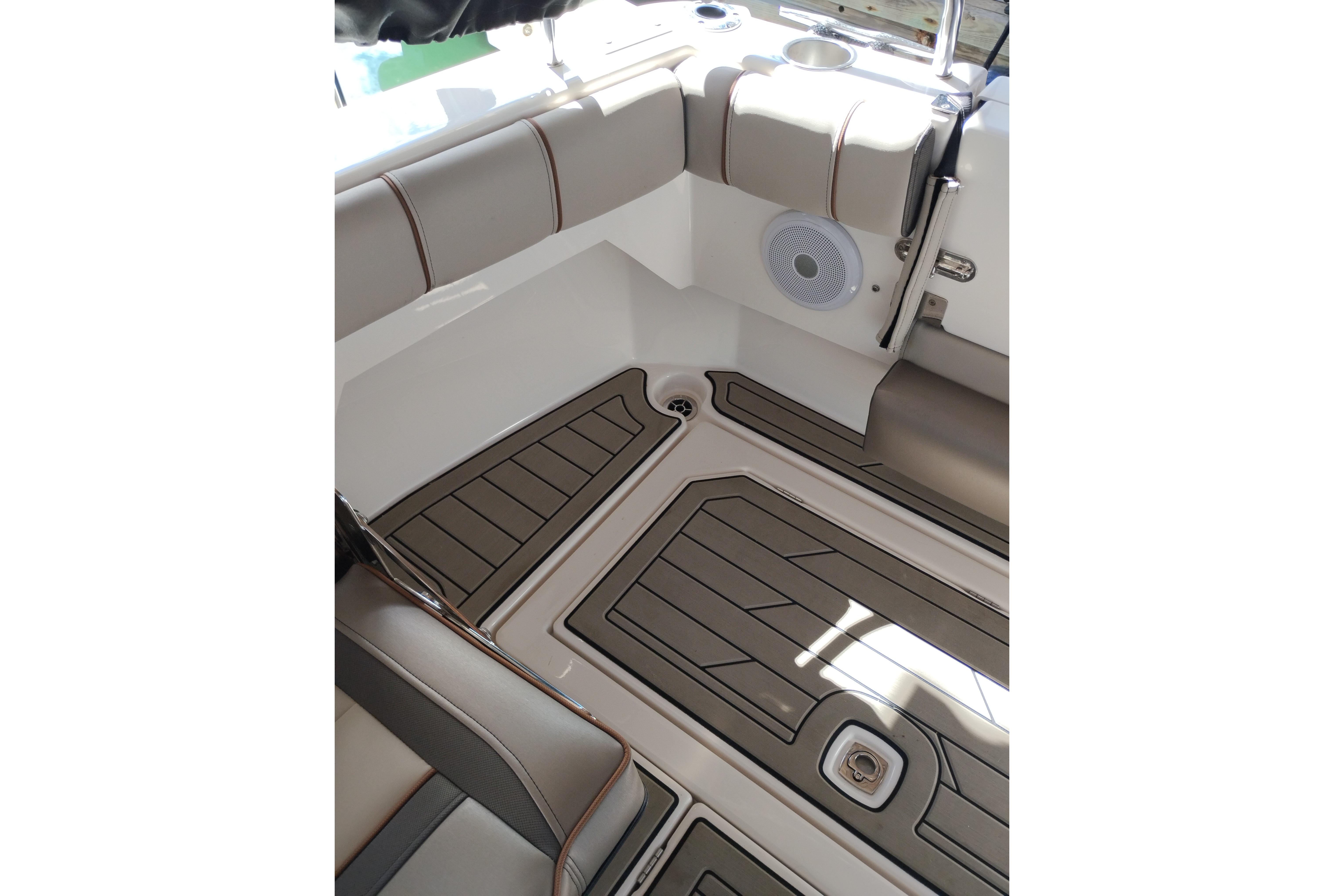 Interior view of 2022 Cutwater C-32 Coupe boat, featuring cushioned seating and speaker.