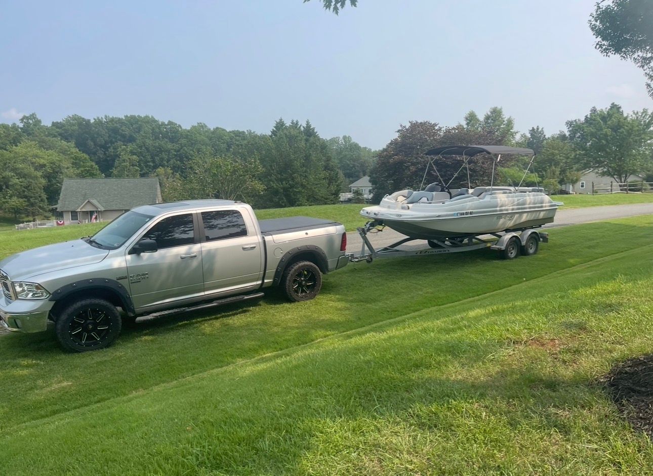 2015 Starcraft Star Step 220 I/O on trailer with pickup truck.