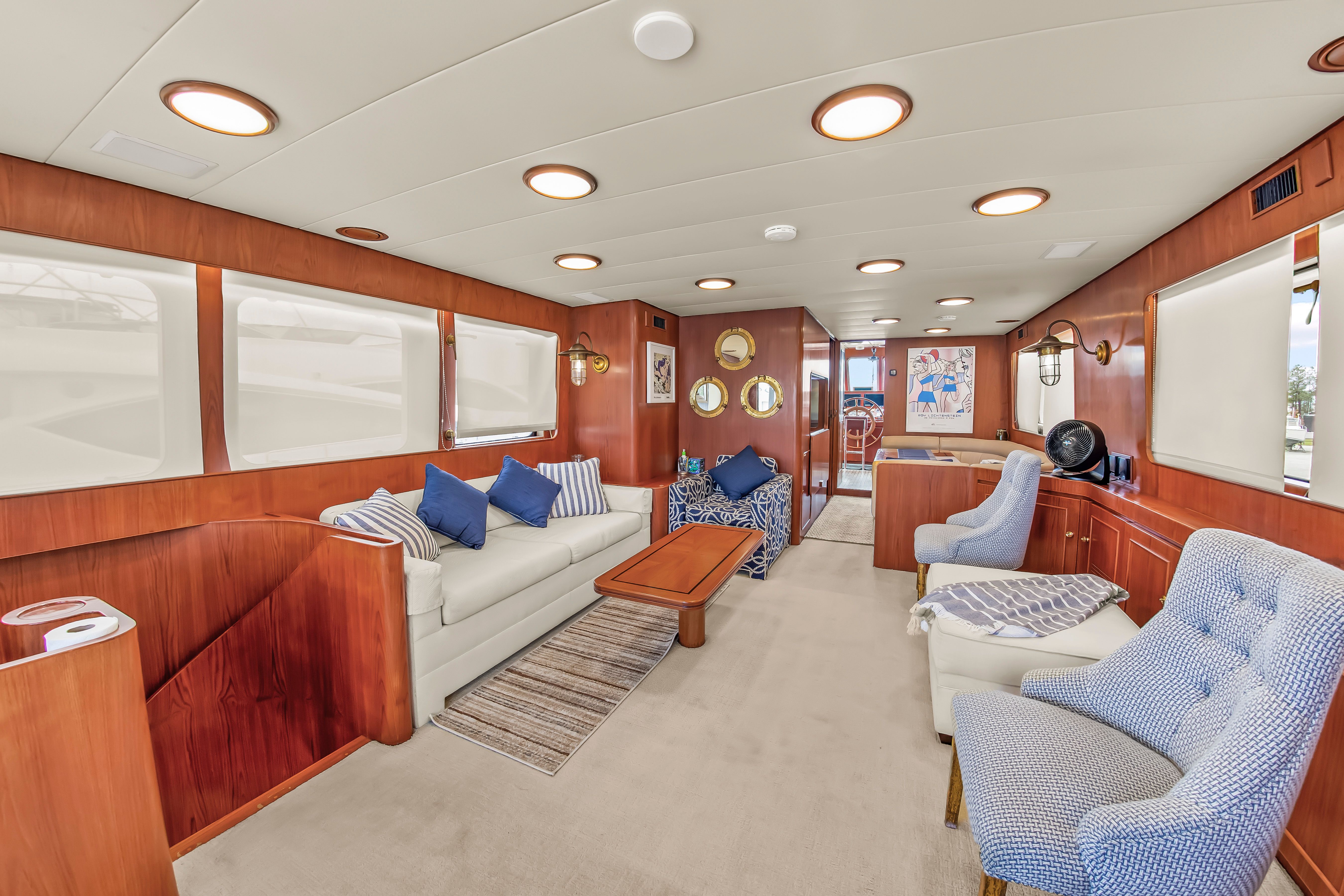 Interior of a 1987 Jongert 78 Motor Yacht with elegant wood paneling and comfortable seating.