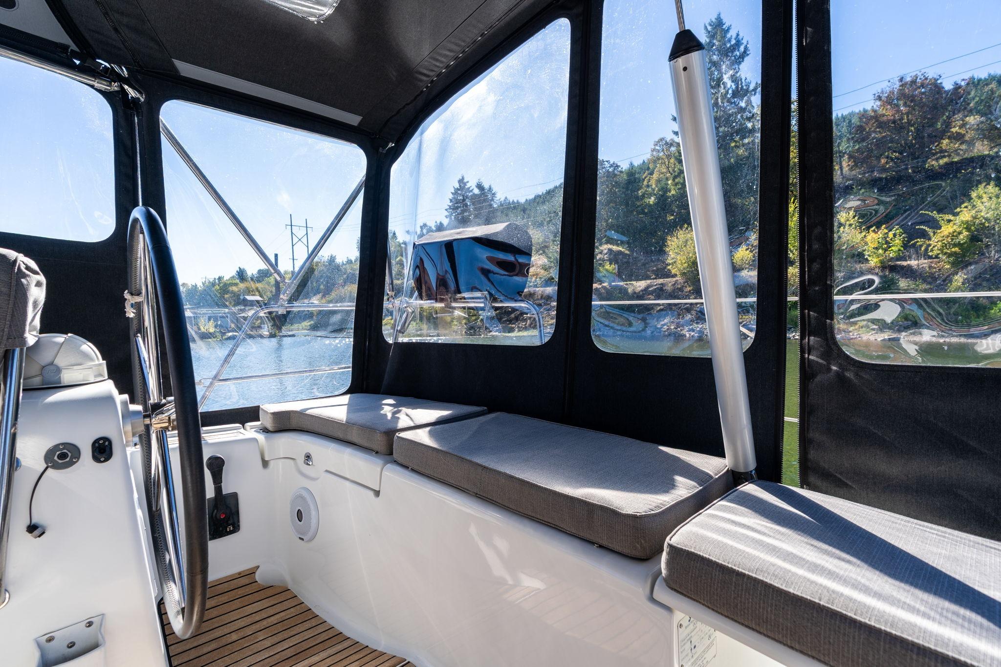 Interior view of 2013 Beneteau Oceanis 50 sailboat cockpit with seating and steering wheel.