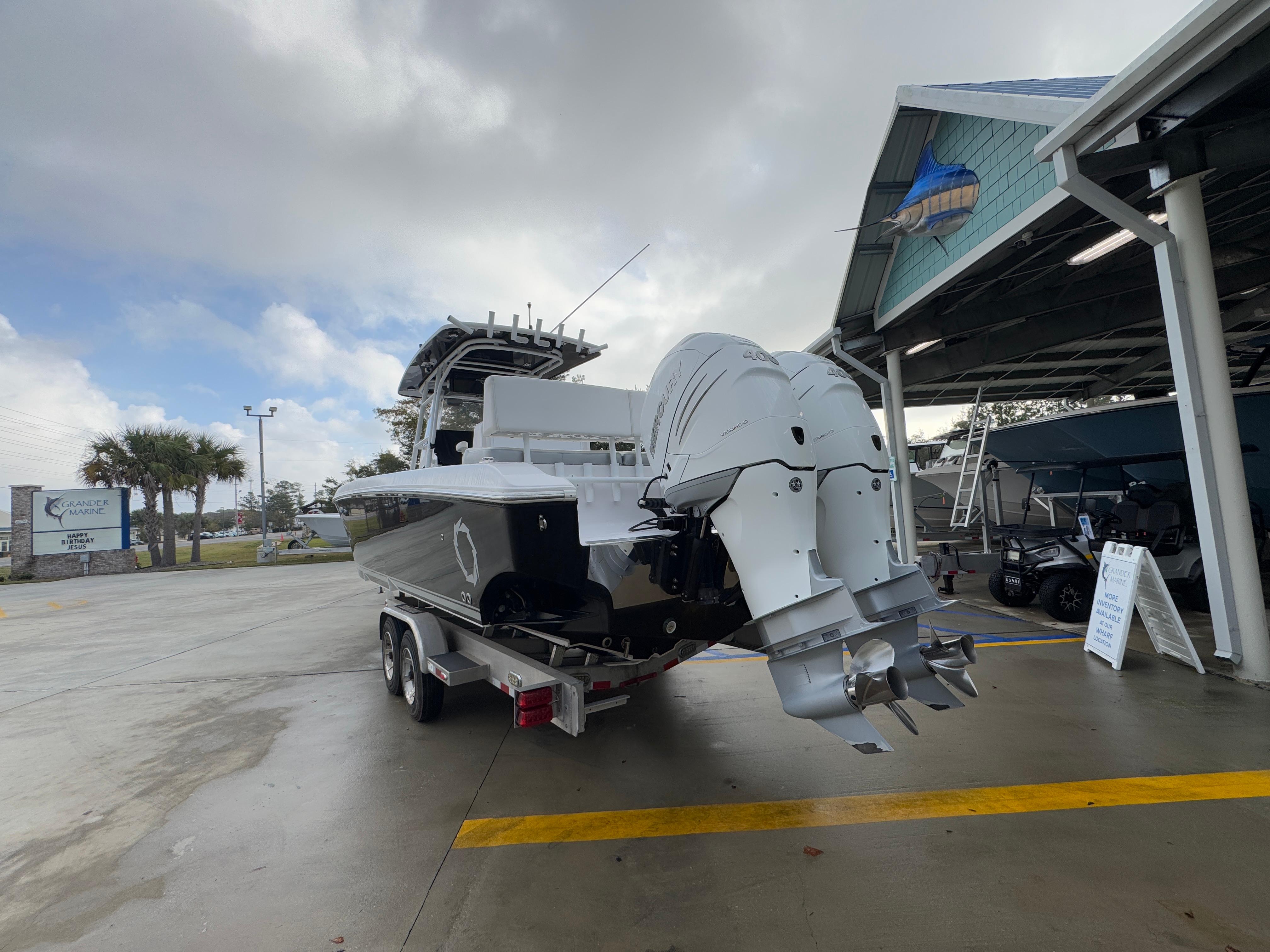 2018 Fountain 34 CC boat on trailer at marina, overcast sky.