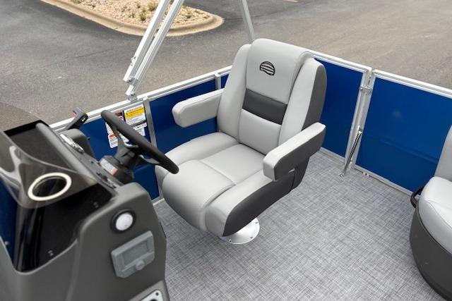 2026 Sun Tracker Party Barge 16 DLX interior with captain's chair and steering console.