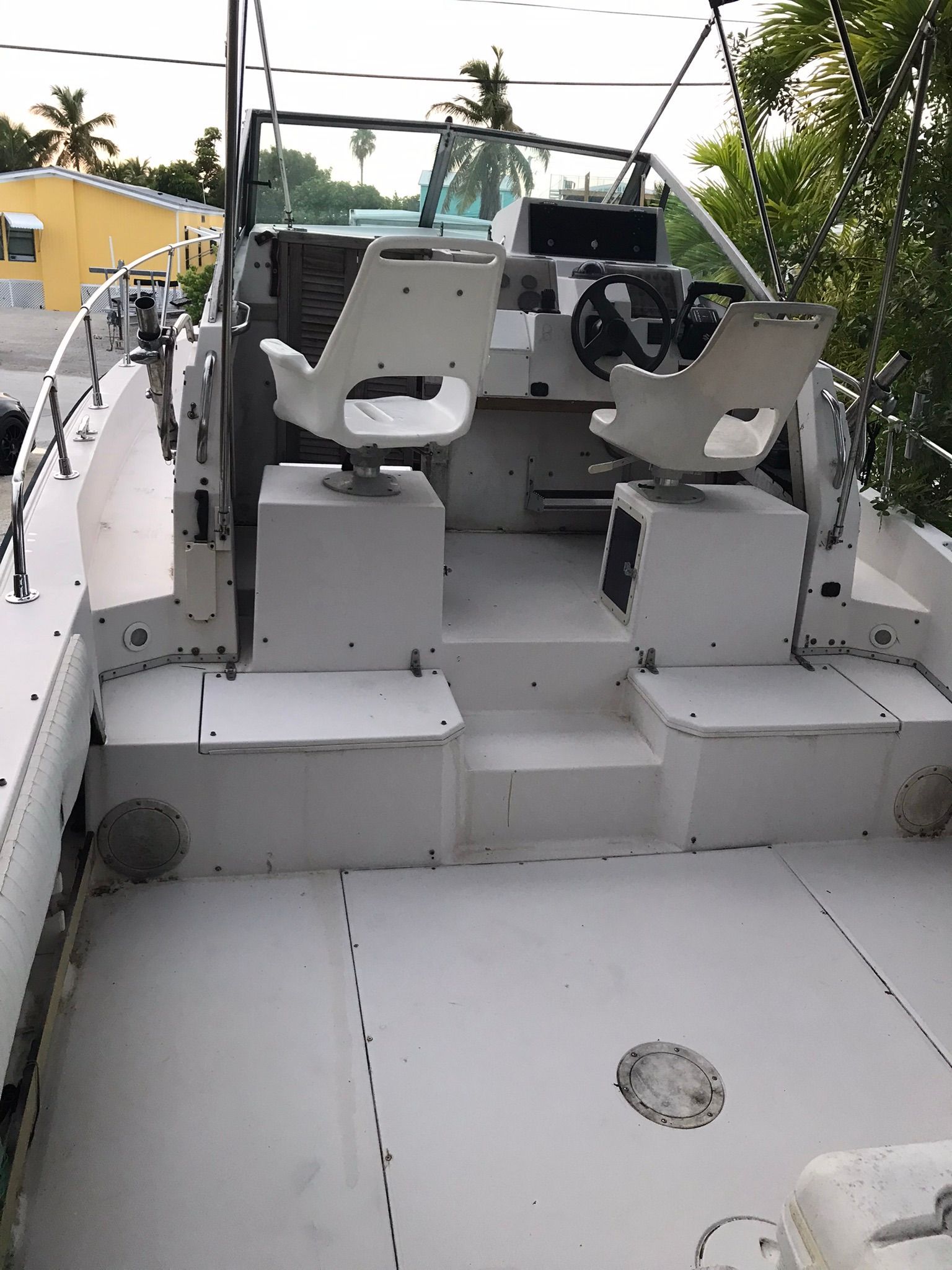 The image shows the cockpit of a 1990 Grady-White Sailfish with two white seats.