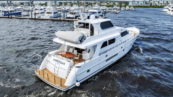 Grand Harbour 76 yacht from 2001 cruising near a marina.