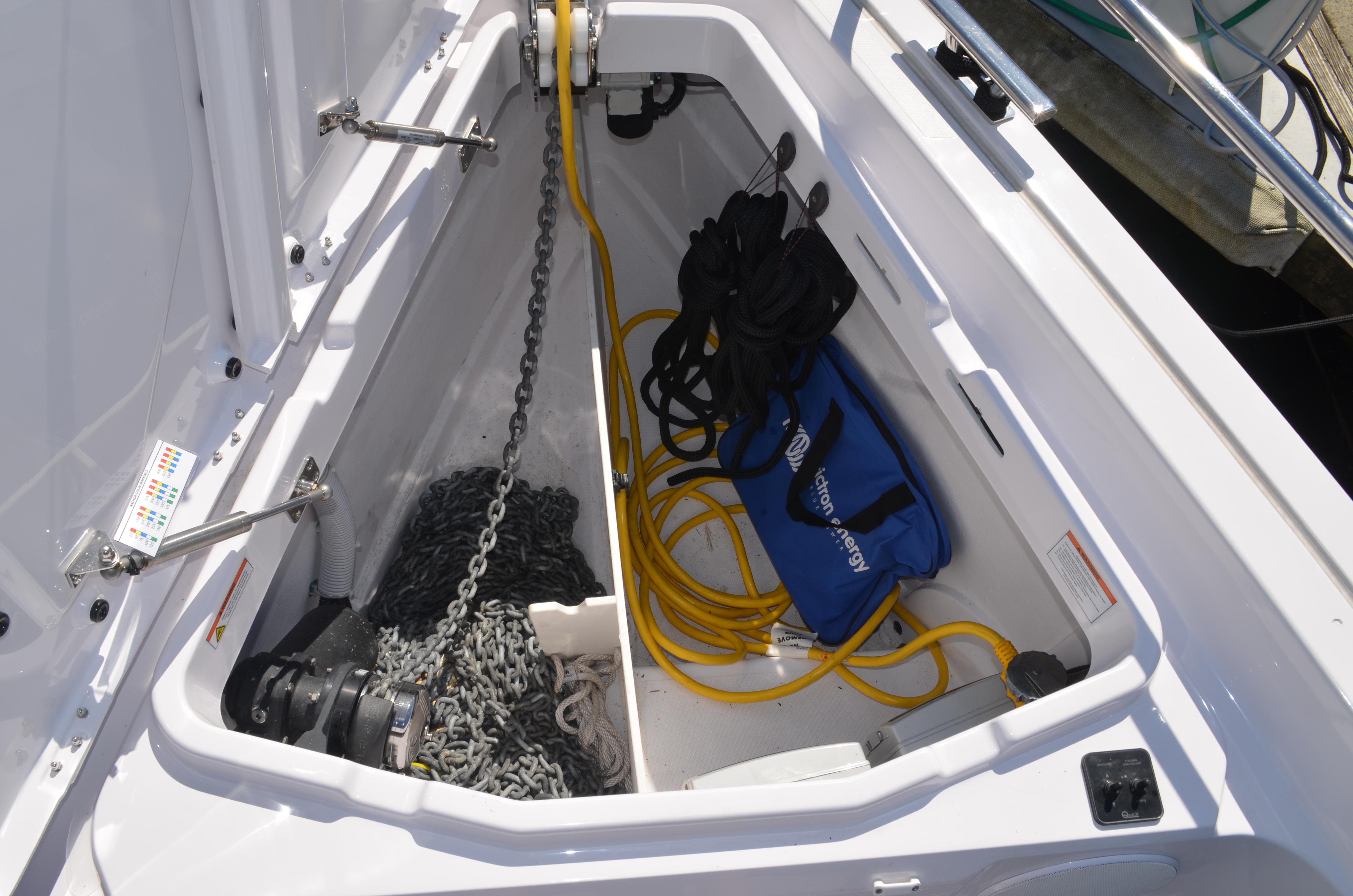 2023 Axopar 45 XC Cross Cabin storage compartment with chains, ropes, and equipment.