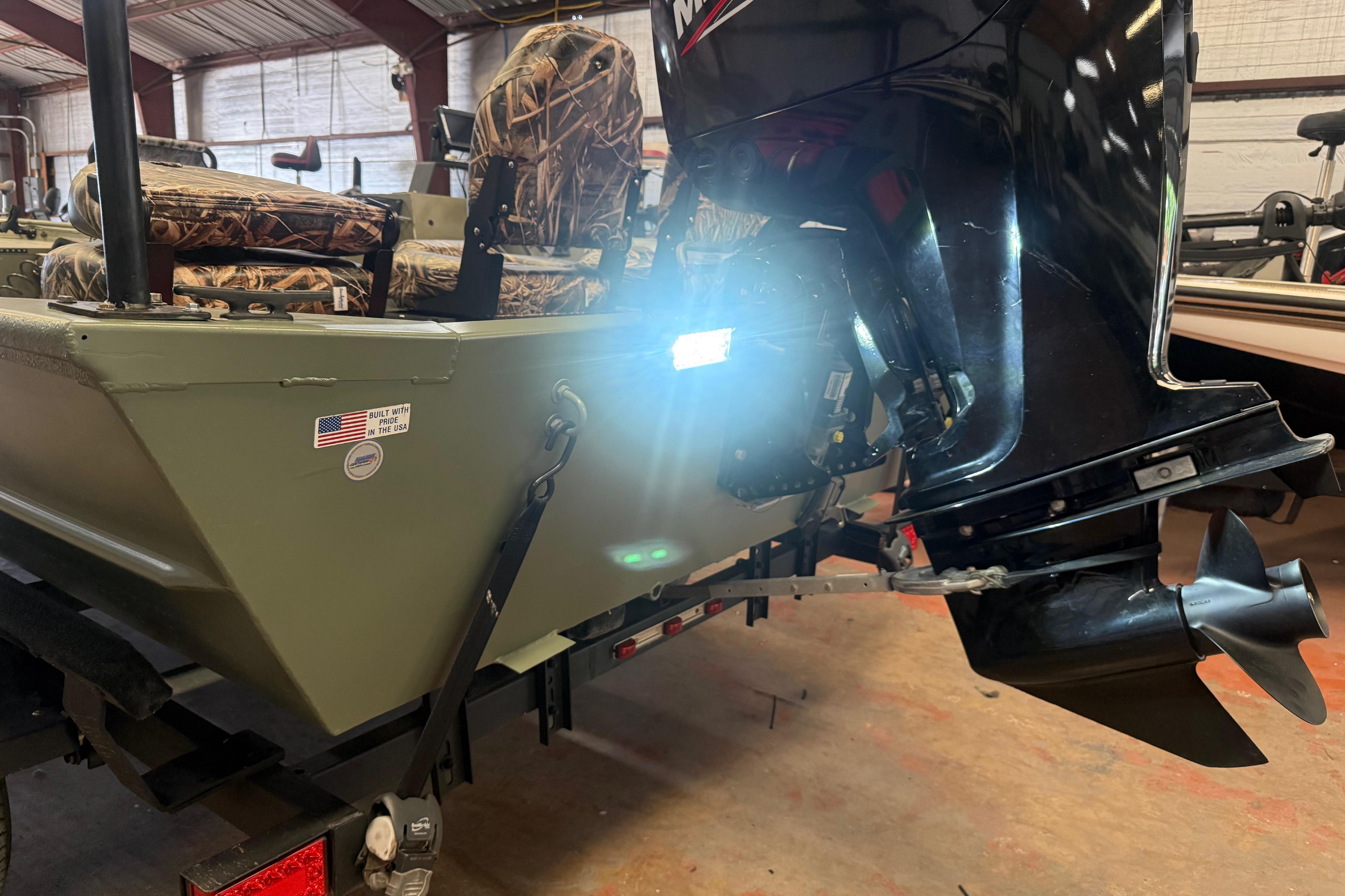 2020 Lowe Roughneck 2070 Big River boat with camo seats and outboard motor.