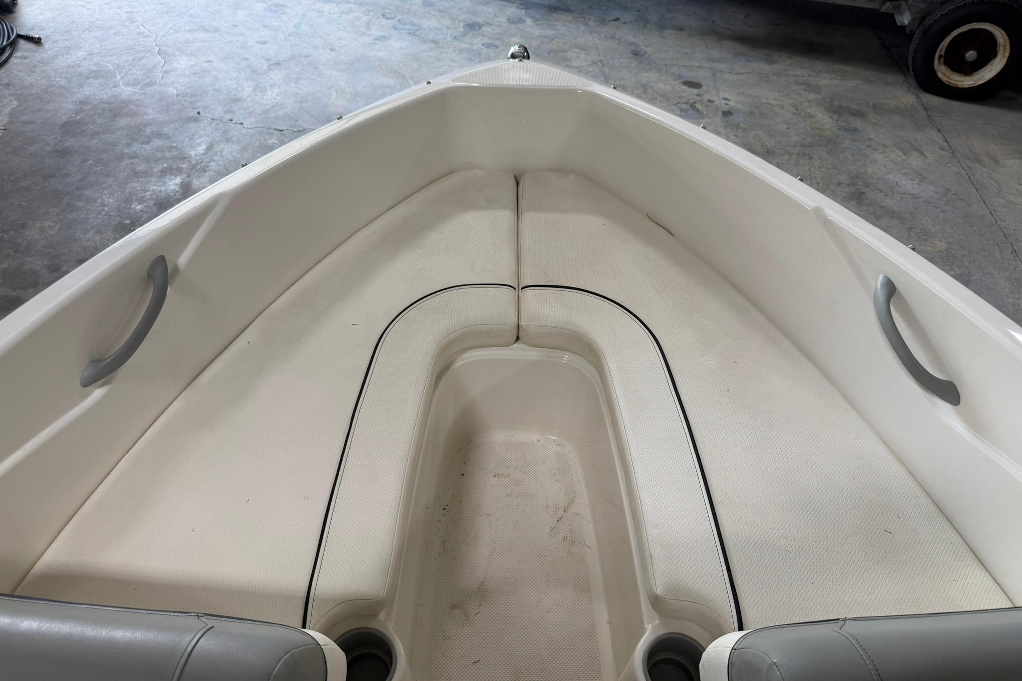 2012 Bayliner 175 Bowrider interior with white seating and gray handles.