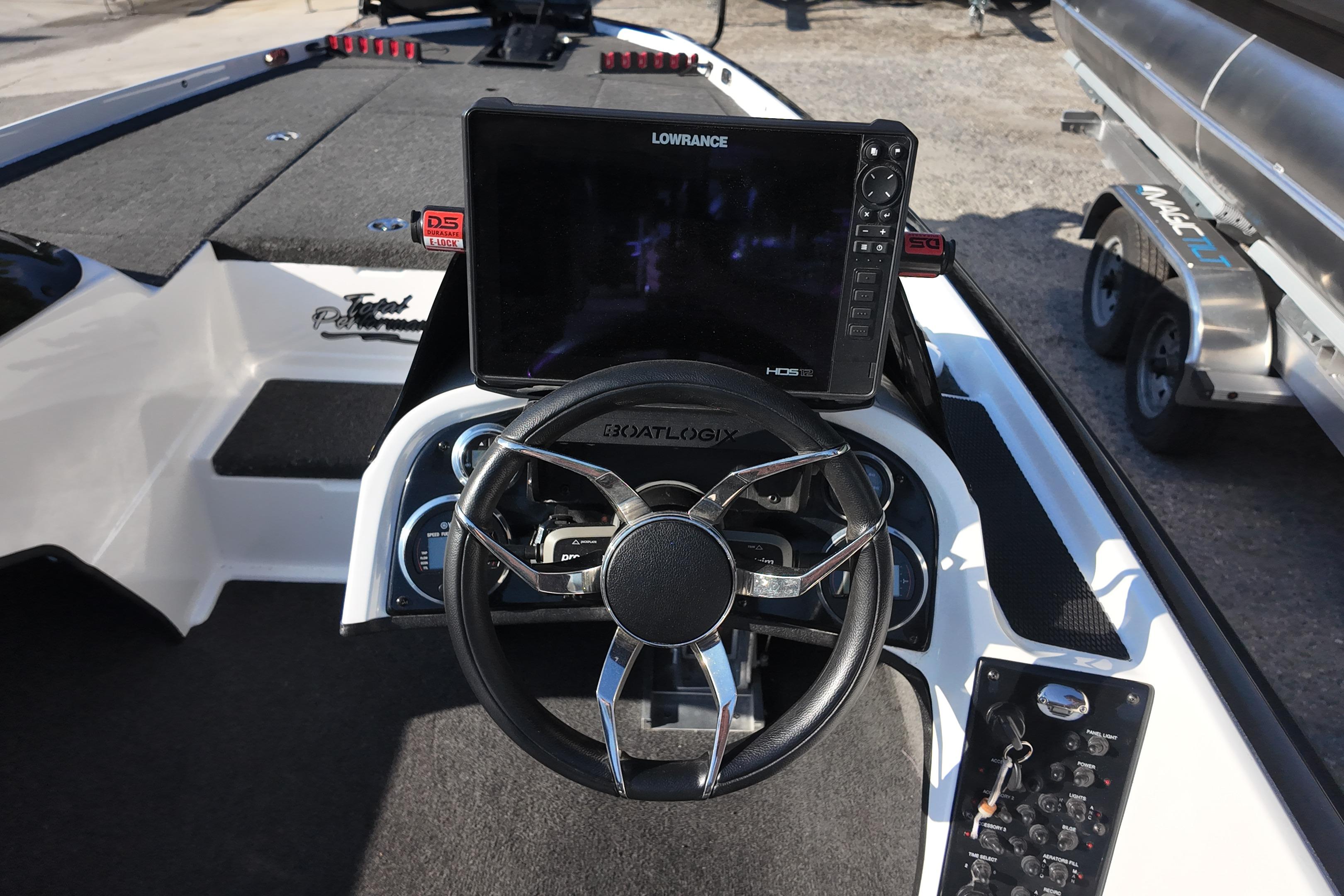 Cockpit of 2022 Bullet 21SDC boat with steering wheel and Lowrance HDS display.