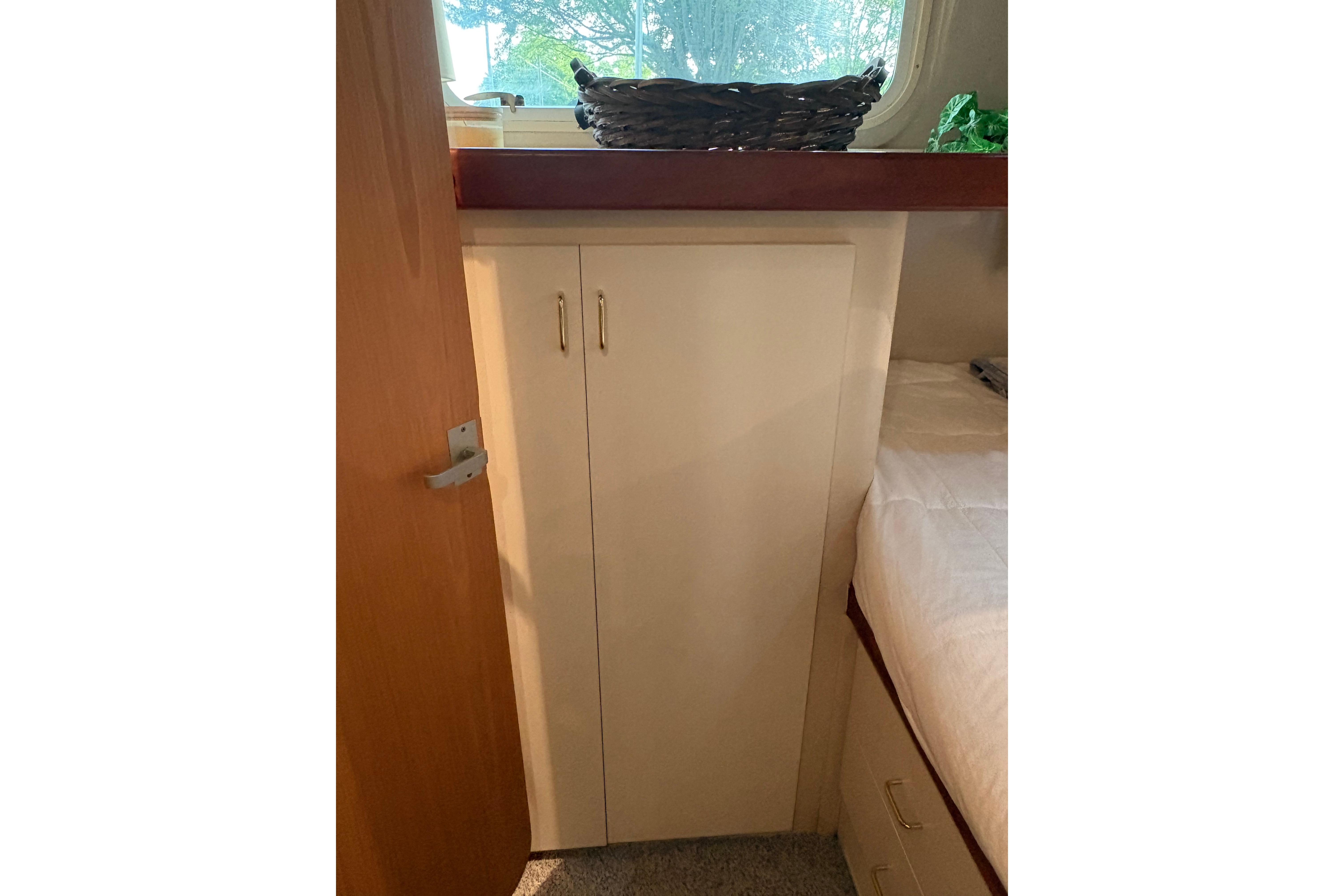 Interior of 1997 Mainship 34 Motor Yacht with cabinet and window view.