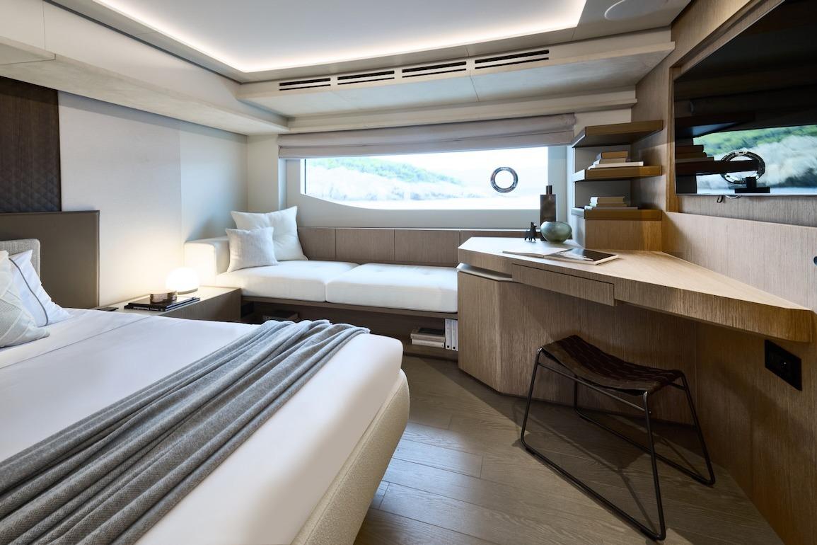 Luxurious Prestige M7 2025 yacht interior with modern bedroom and sleek wooden desk.