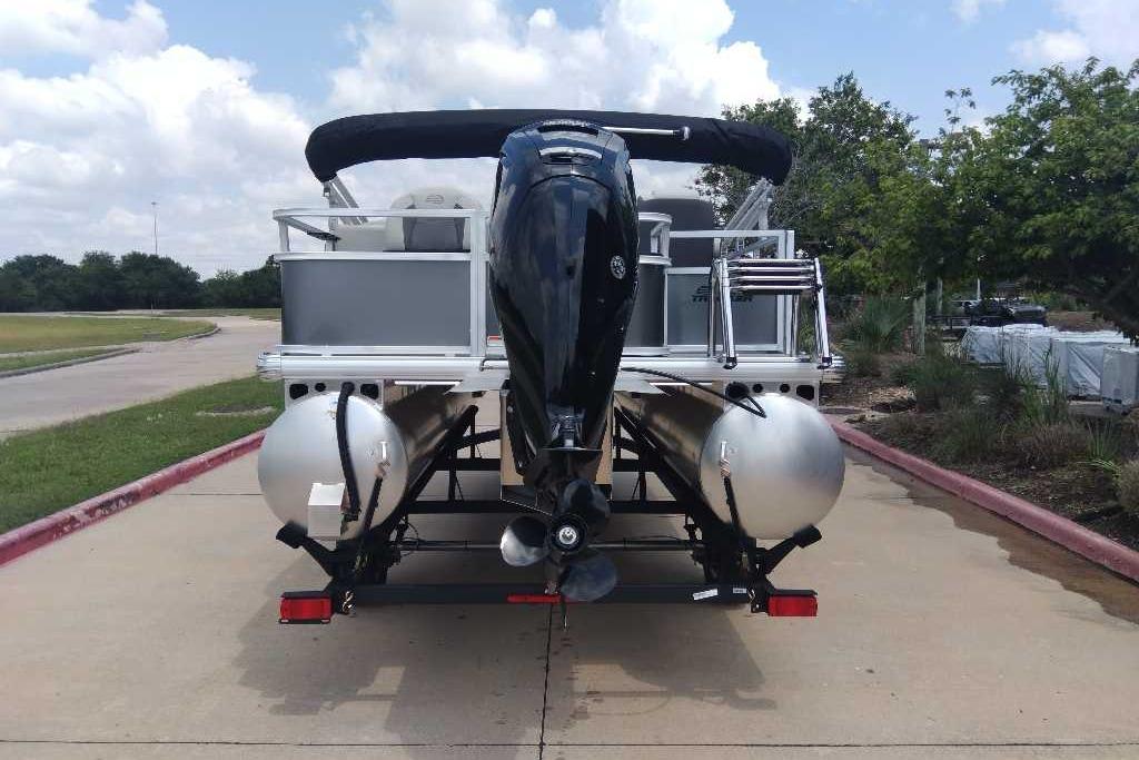 2026 Sun Tracker Bass Buggy 18 DLX pontoon boat on trailer, rear view.