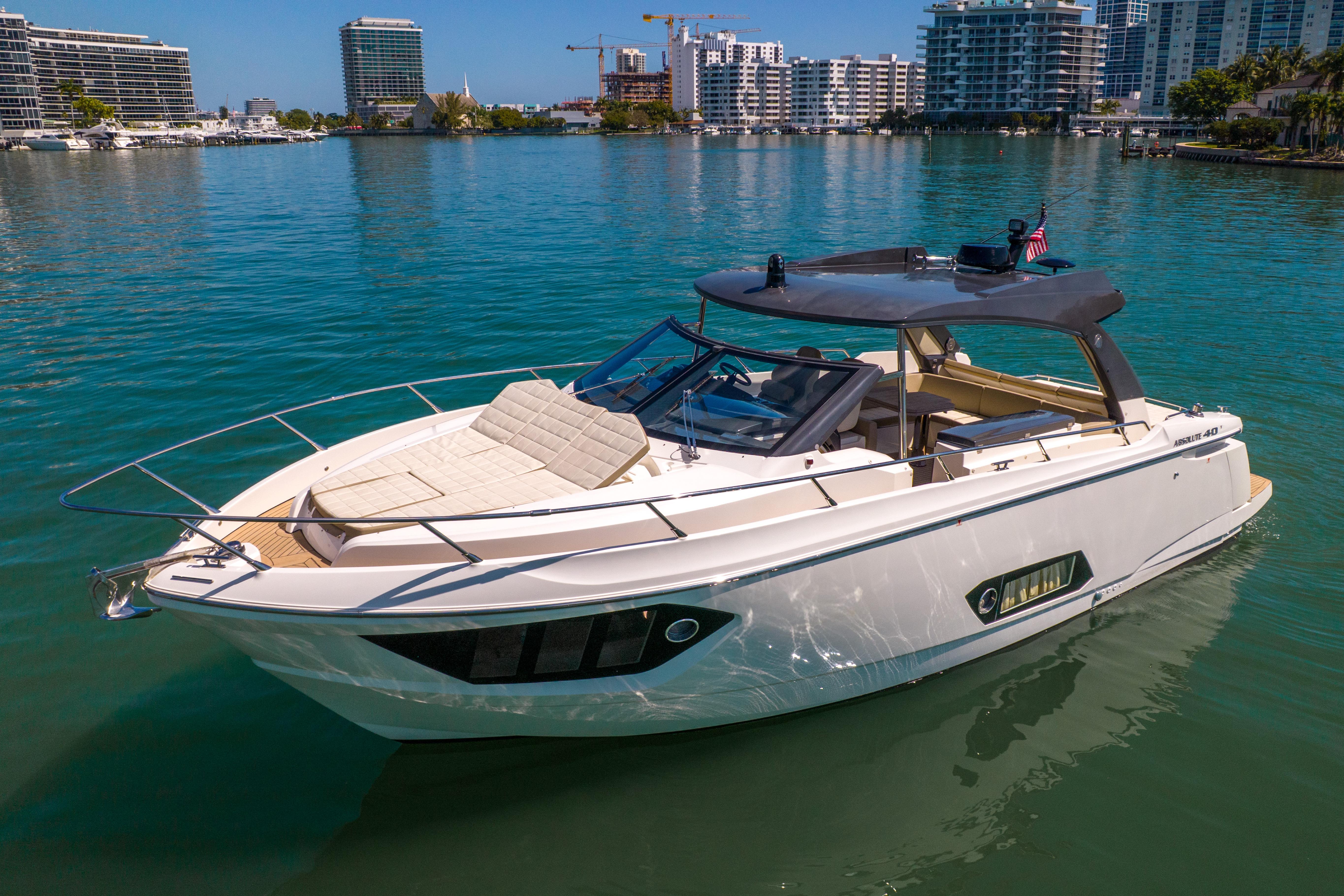 2017 Absolute 40 STL yacht on calm water, surrounded by modern cityscape.