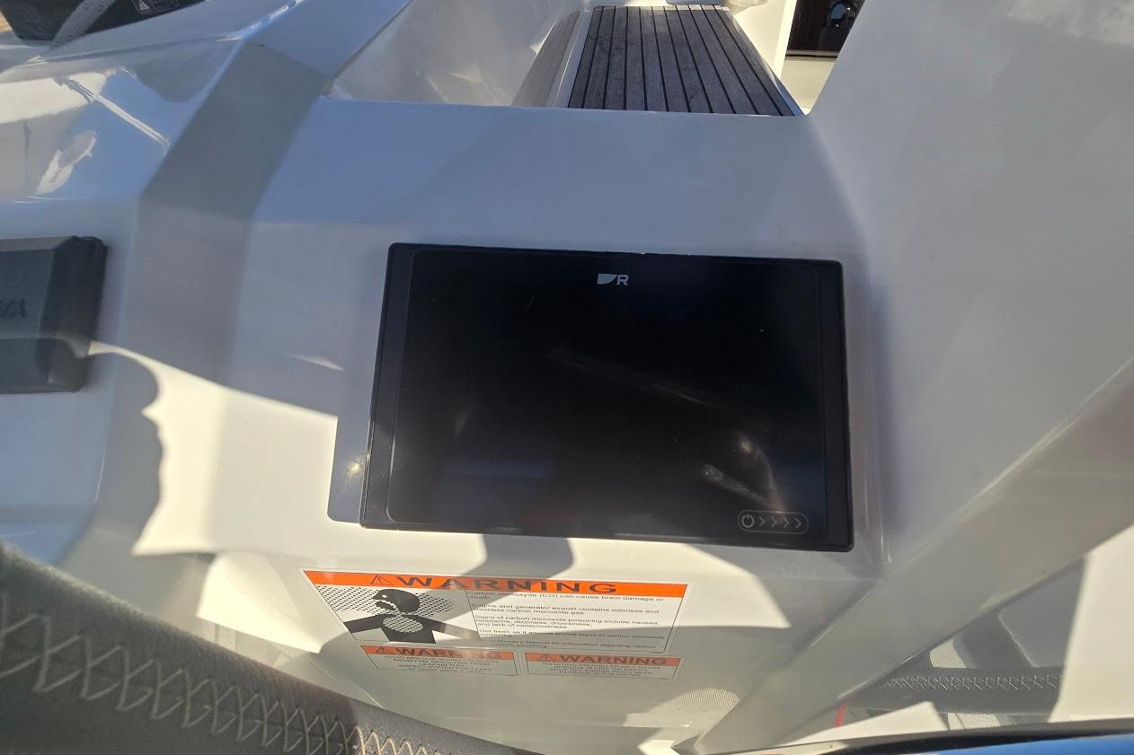 Control panel on 2023 Beneteau Oceanis 38.1 yacht, featuring a digital display and warning label.