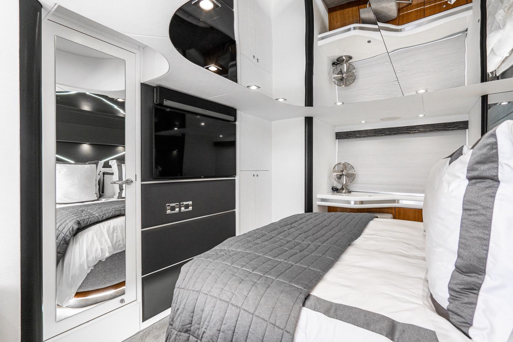 Luxurious interior of 2021 Sunseeker Predator 68 yacht bedroom with modern design.