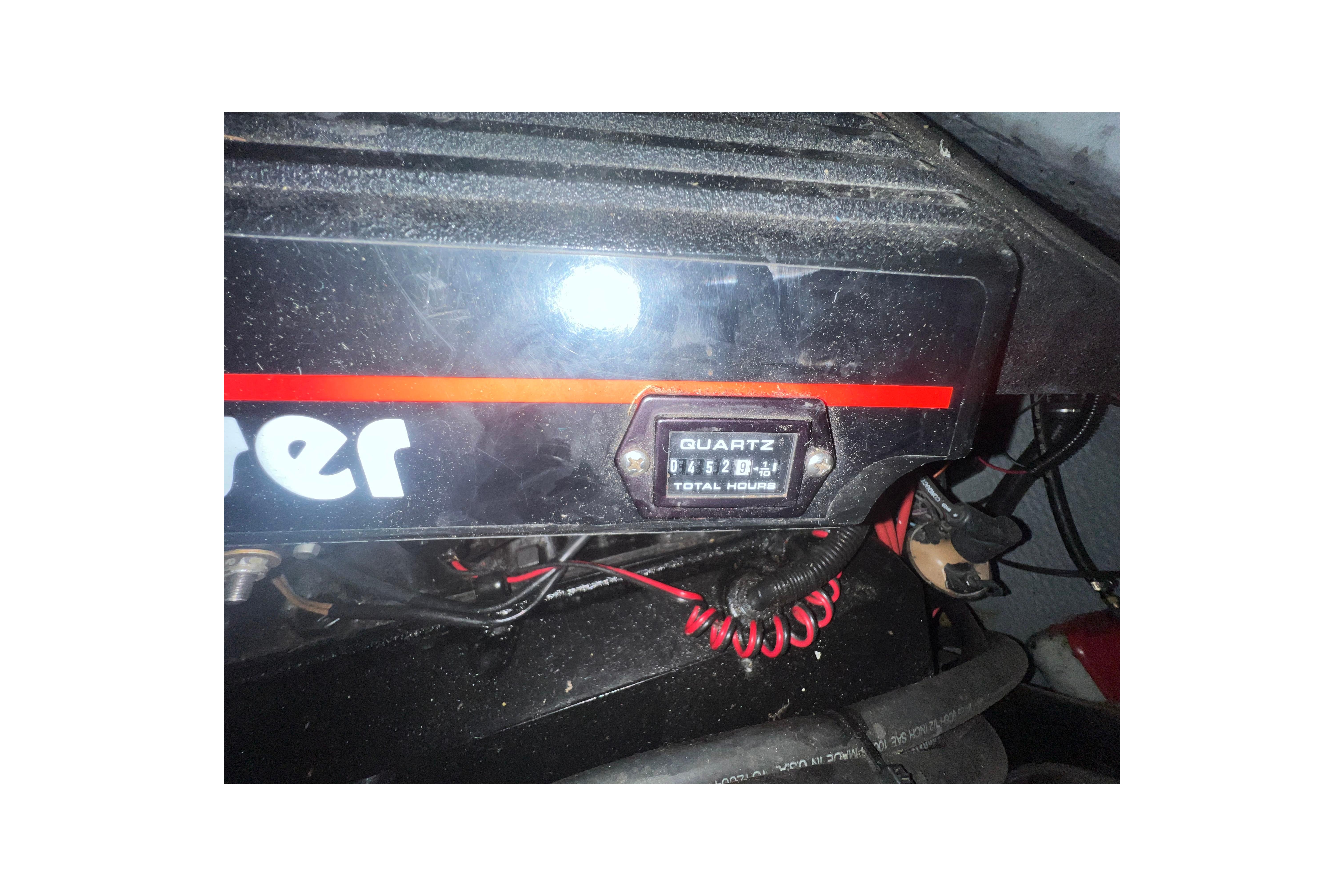 Engine compartment of 1995 Rinker Fiesta Vee 265 with hour meter display.