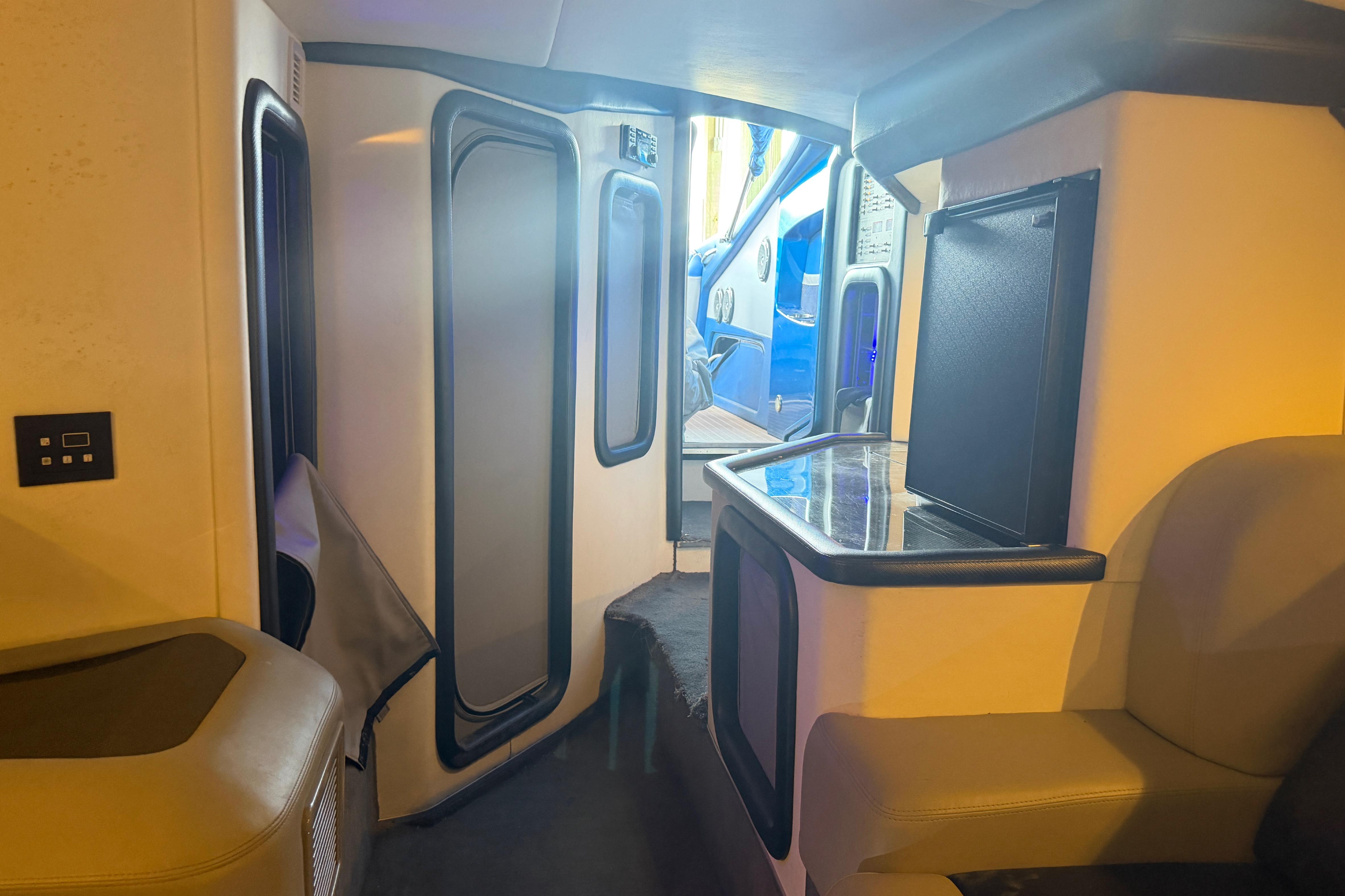 Interior of a 2013 Nor-Tech 477 SPX Vee Bottom boat, featuring seating and a small counter.