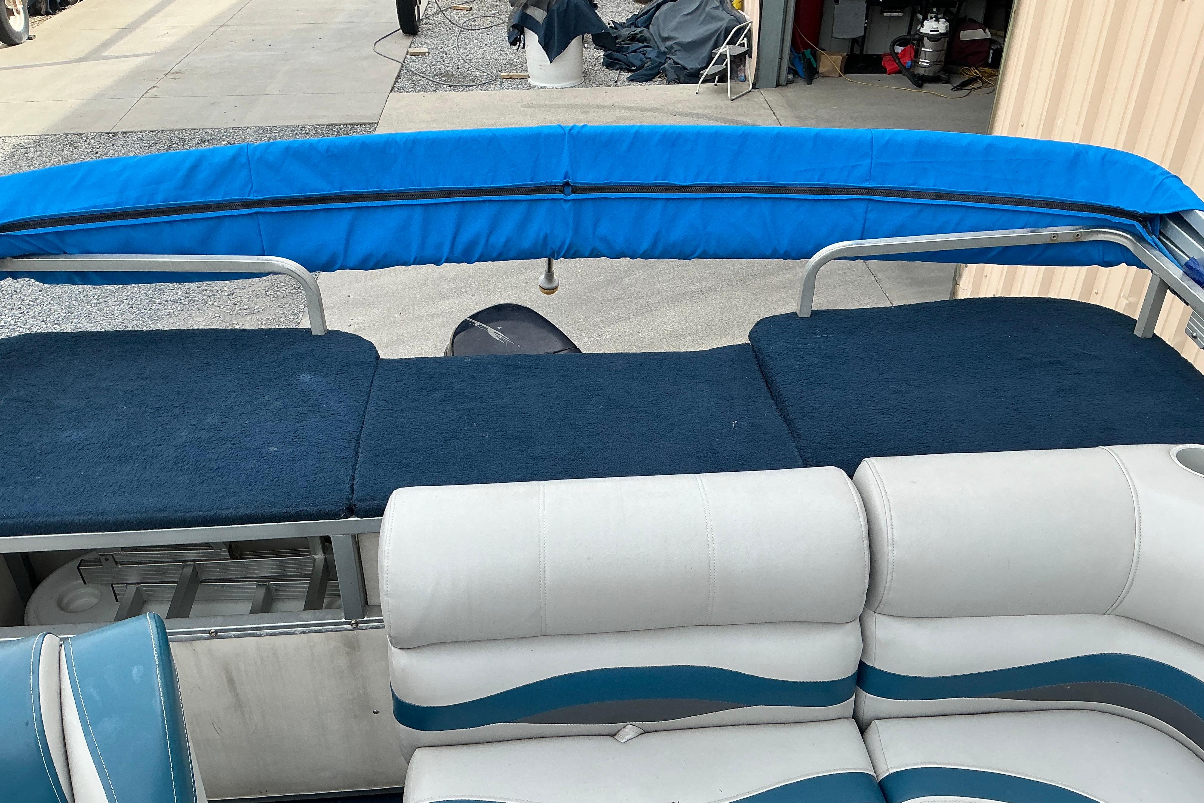 1992 Godfrey Sweetwater 2020 pontoon boat interior with blue and white seating.