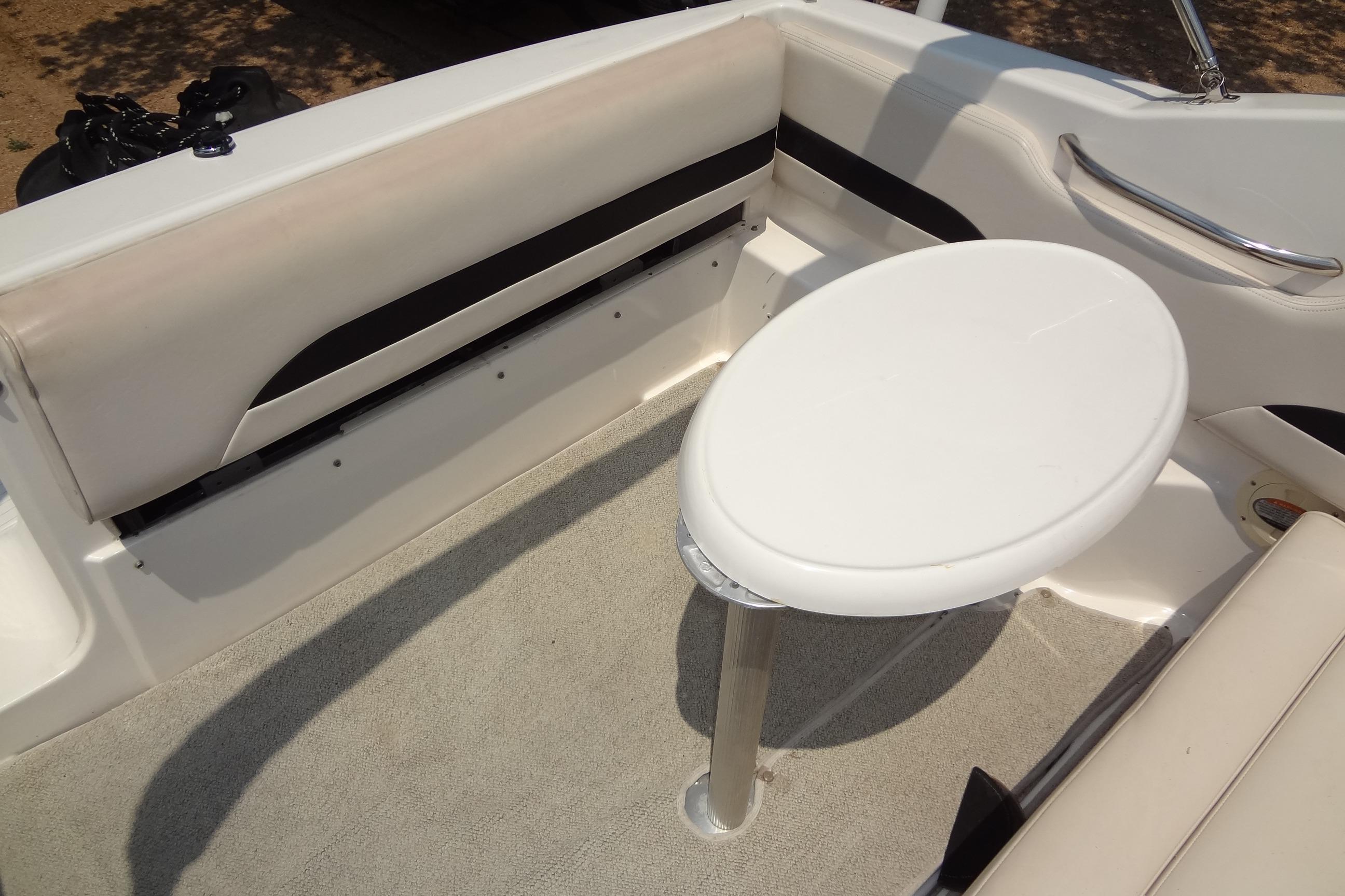 Interior of 2000 Chaparral Signature 260 boat with seating and table.