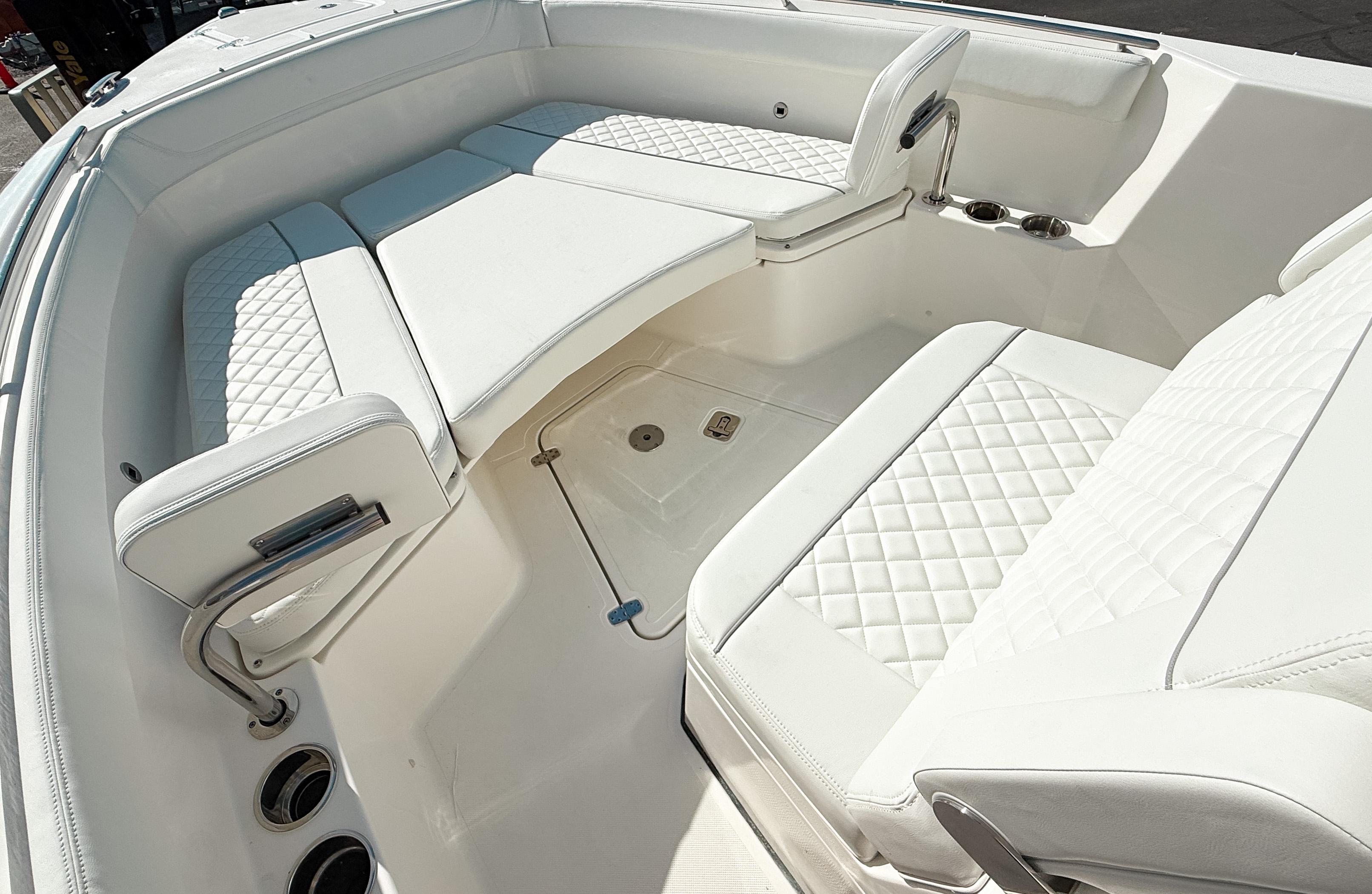 2025 Pursuit S 268 Sport boat interior with white cushioned seating and diamond stitching.