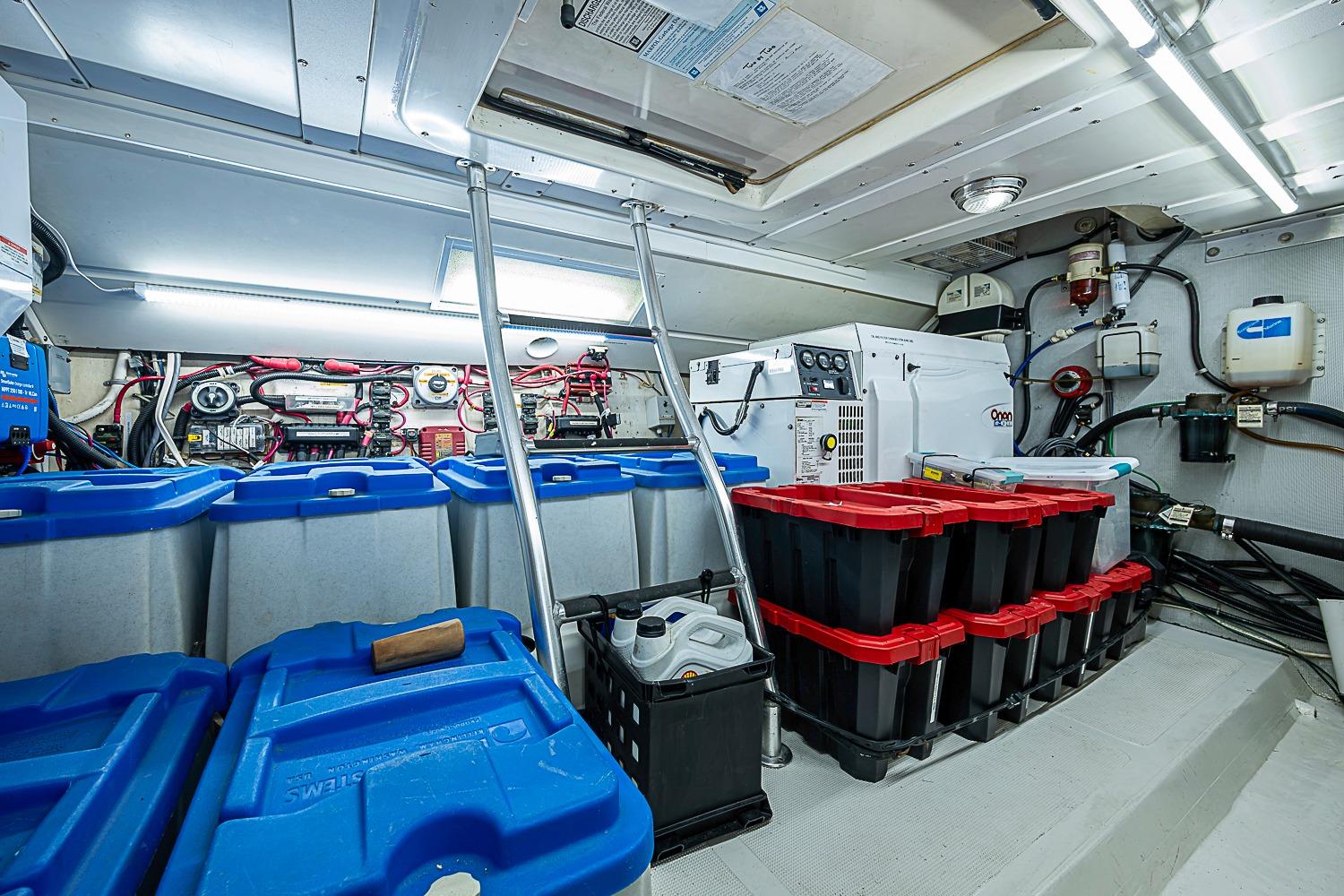 Engine room of 2003 Magna Marine Nova Scotia 47 with storage bins and equipment.