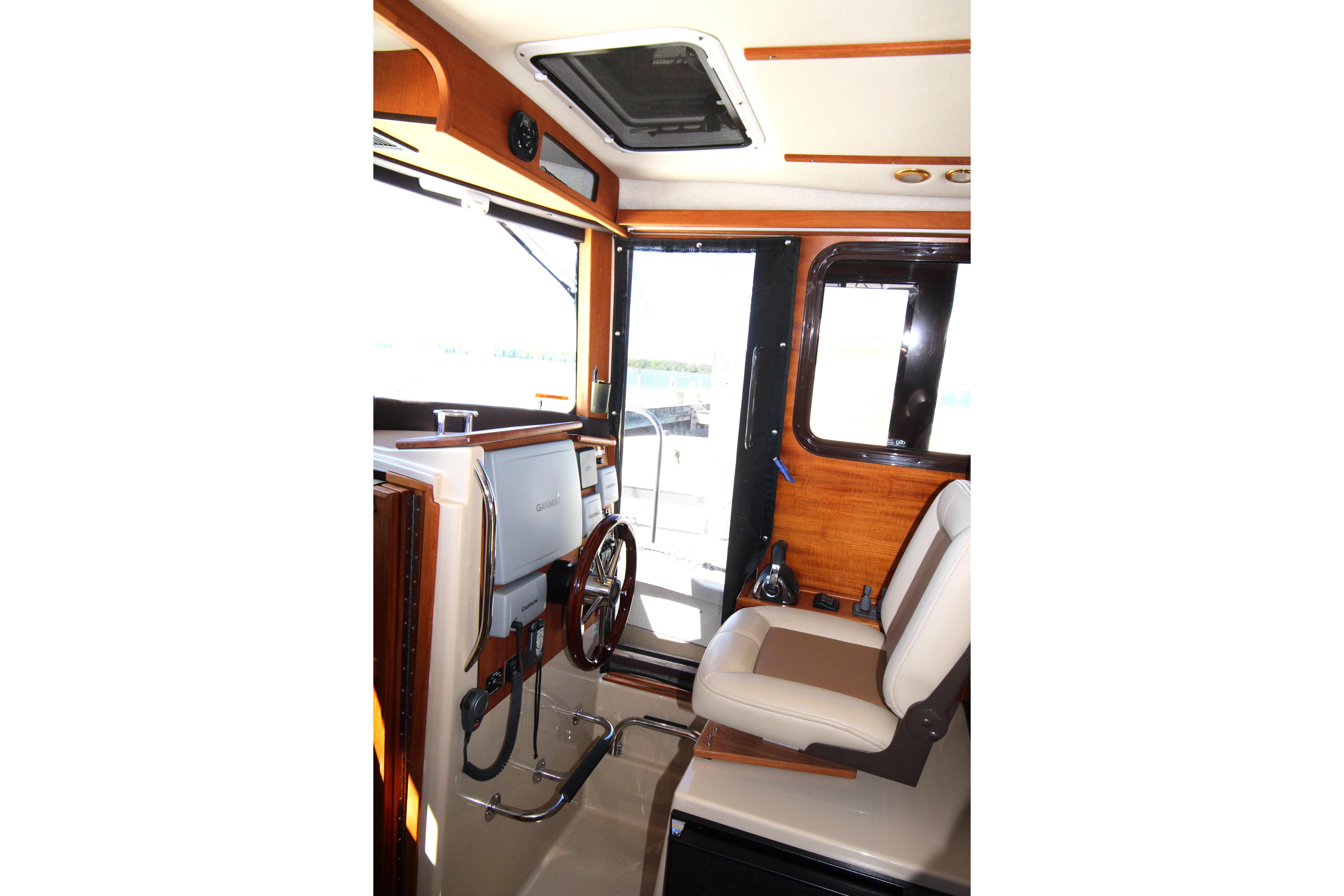 Interior of 2013 Ranger Tugs R-31 CB boat, featuring helm and seating area.