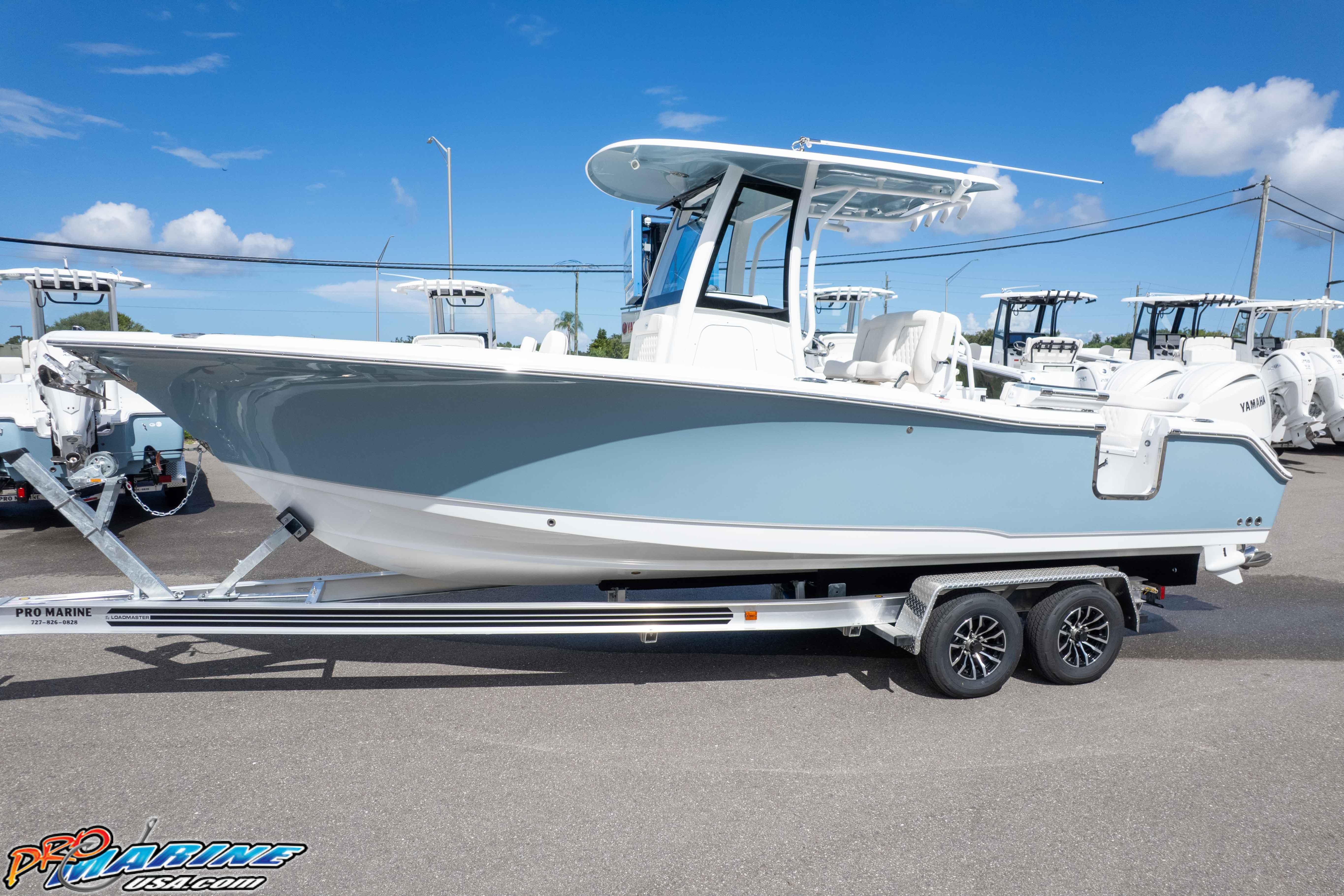 2026 Sea Hunt Ultra 265 SE boat on trailer, displayed outdoors under clear blue sky.