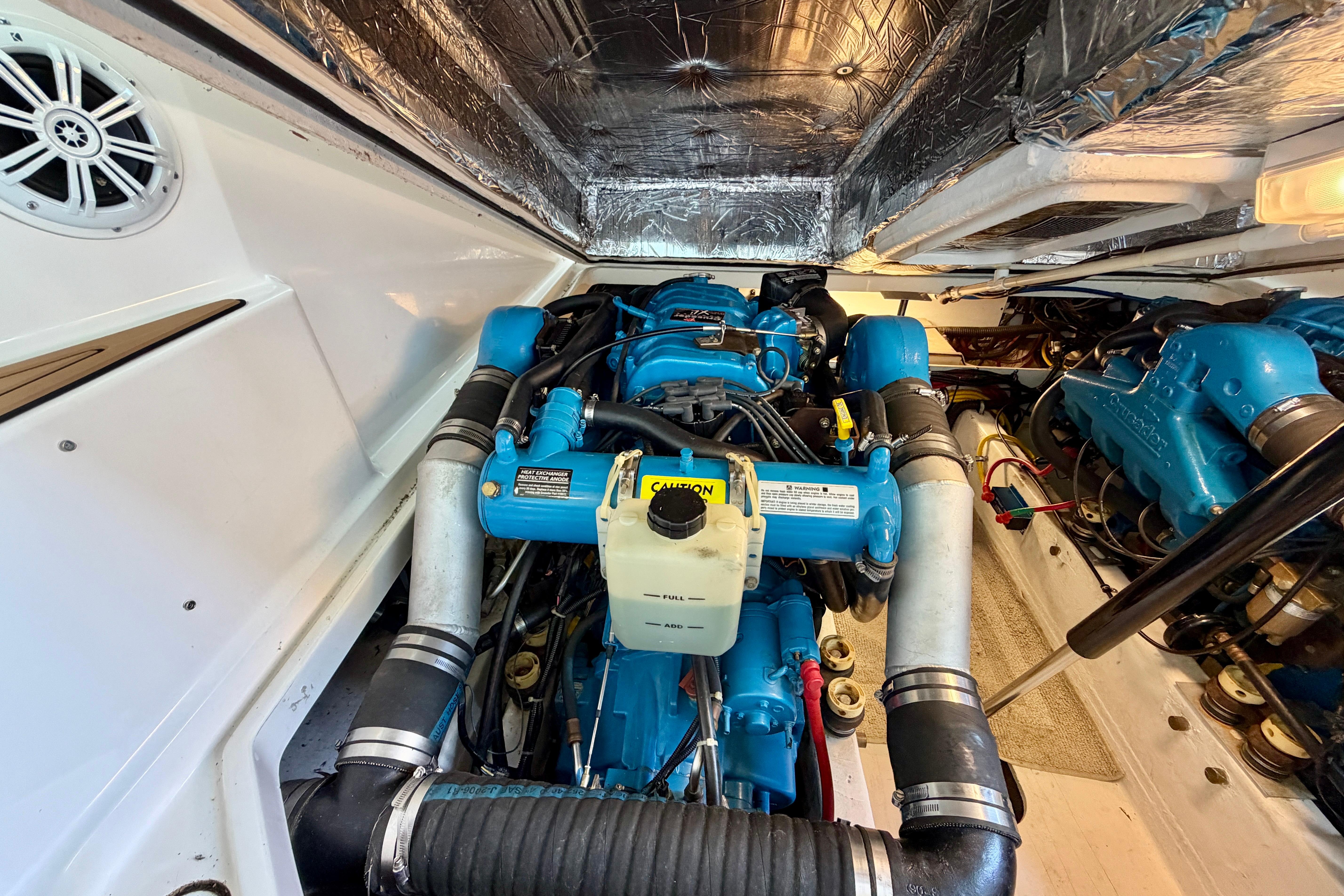 Engine compartment of a 1999 Tiara Yachts 2900 Coronet, showcasing blue engine components.
