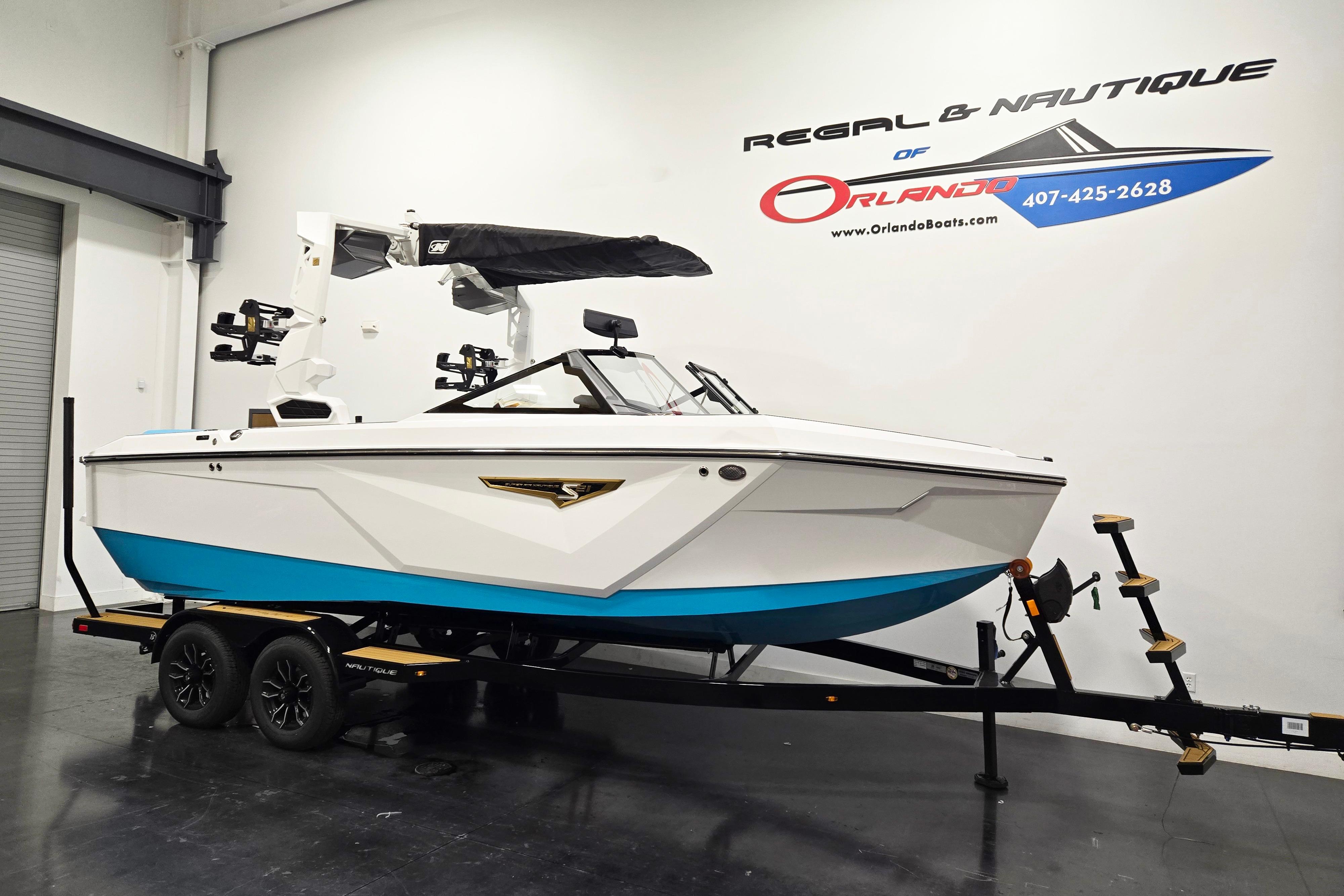 2026 Nautique Super Air Nautique S21 boat on trailer in showroom.