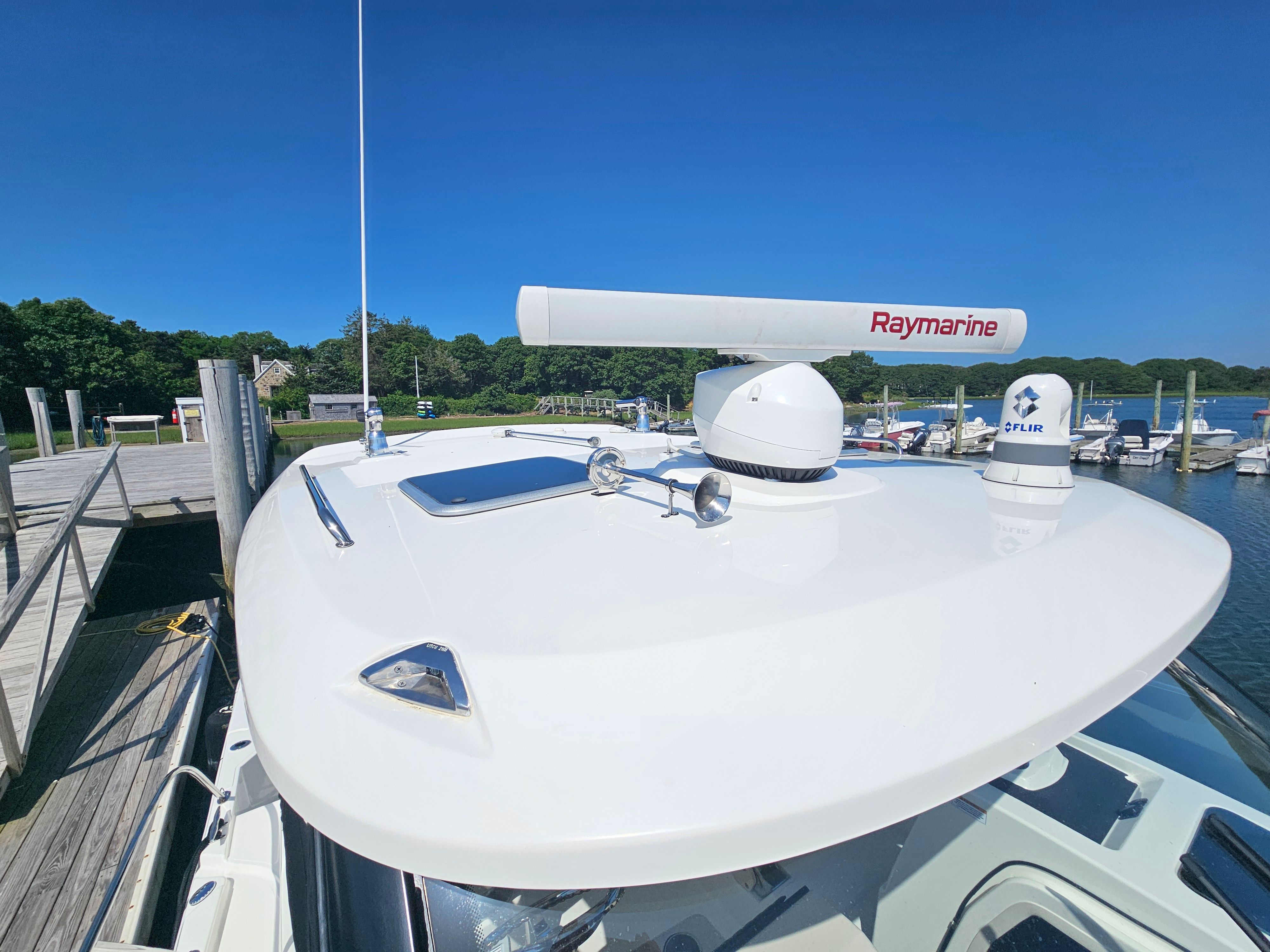 The image shows the roof of a Boston Whaler 325 Conquest with radar and antenna.