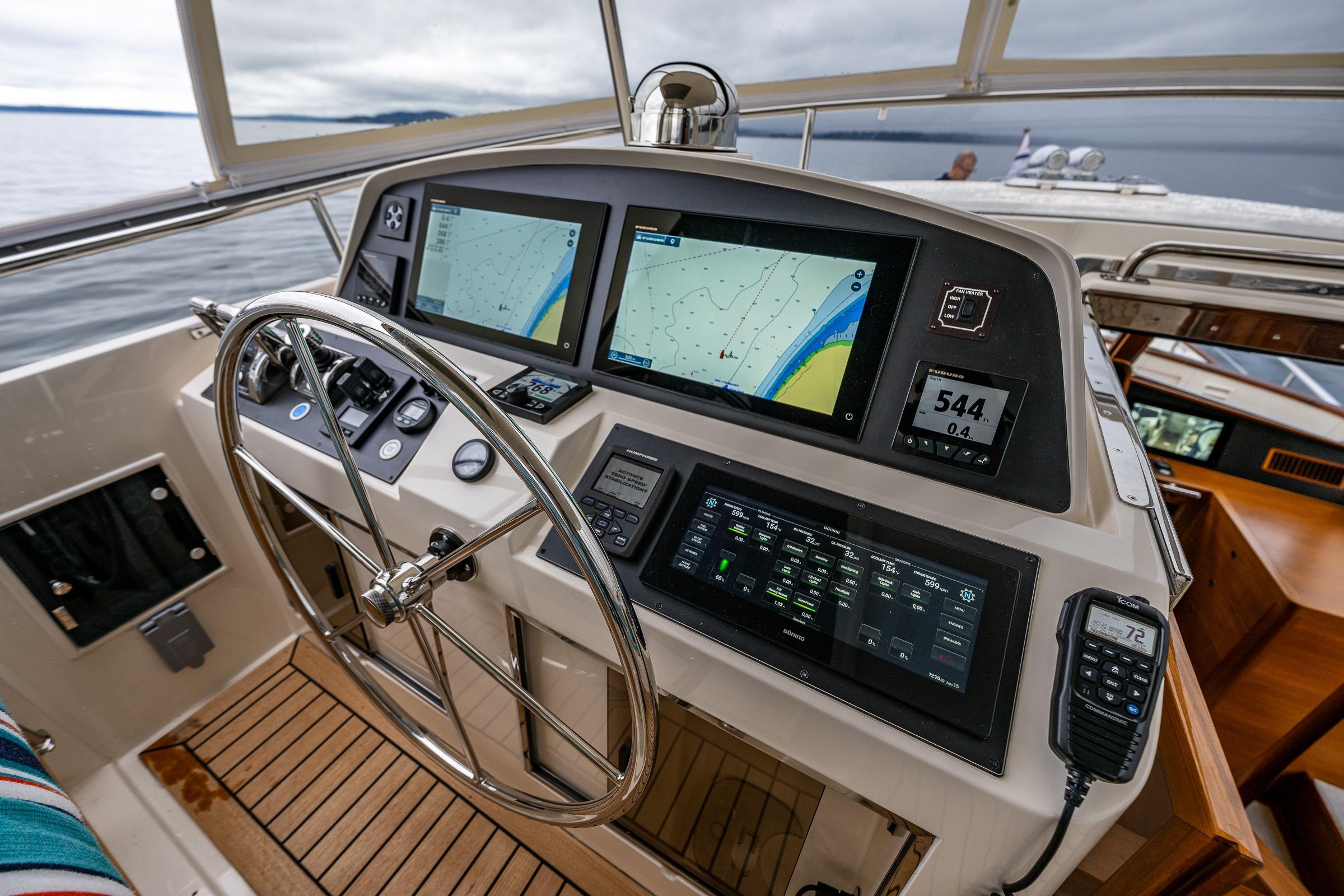 2026 Fleming 55 Pilothouse helm with advanced navigation displays and controls.