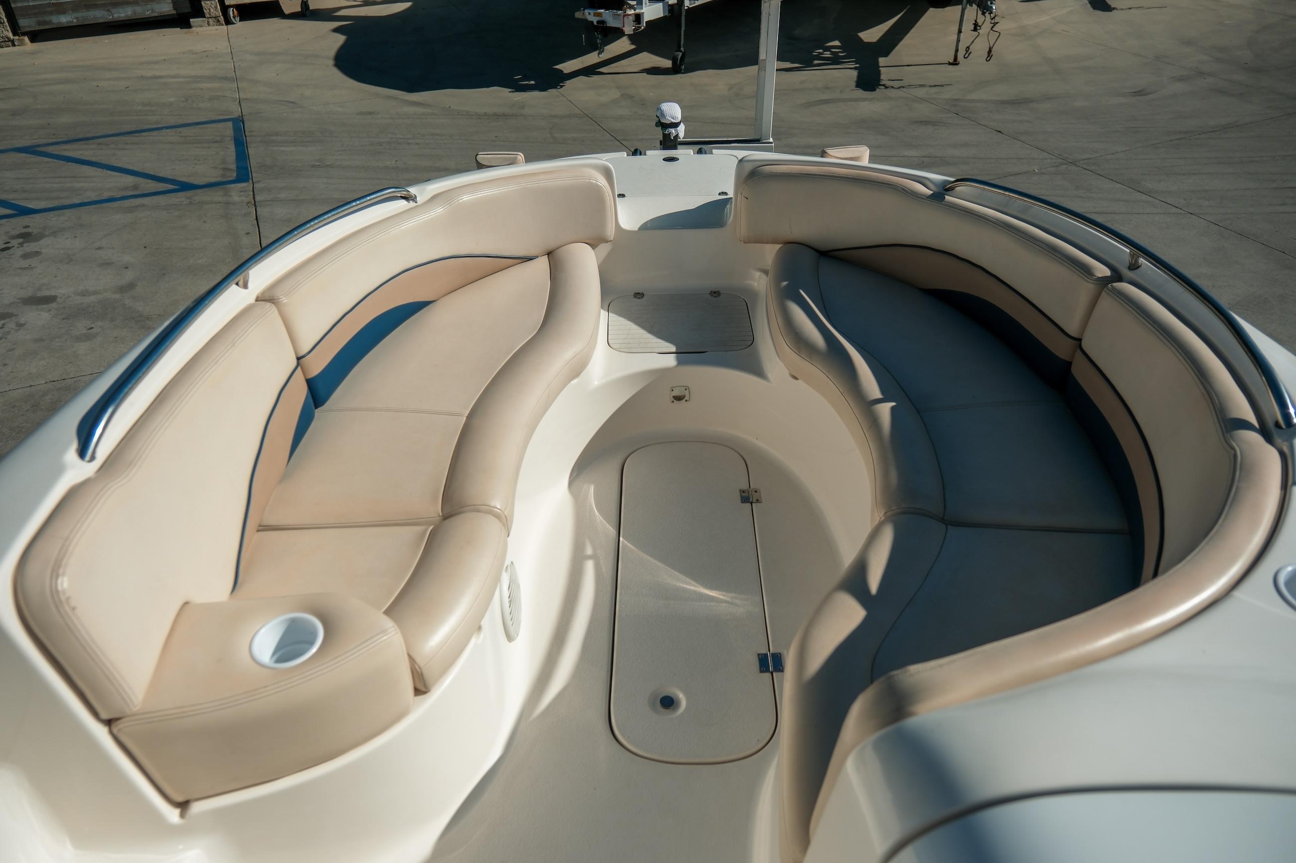 1998 Chaparral 232 Sunesta boat interior with beige seating and cup holders.