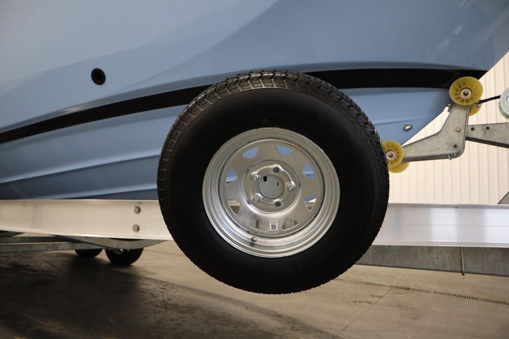 2026 Yamaha Boats 255 FSH Sport E on trailer, showcasing hull and wheel detail.