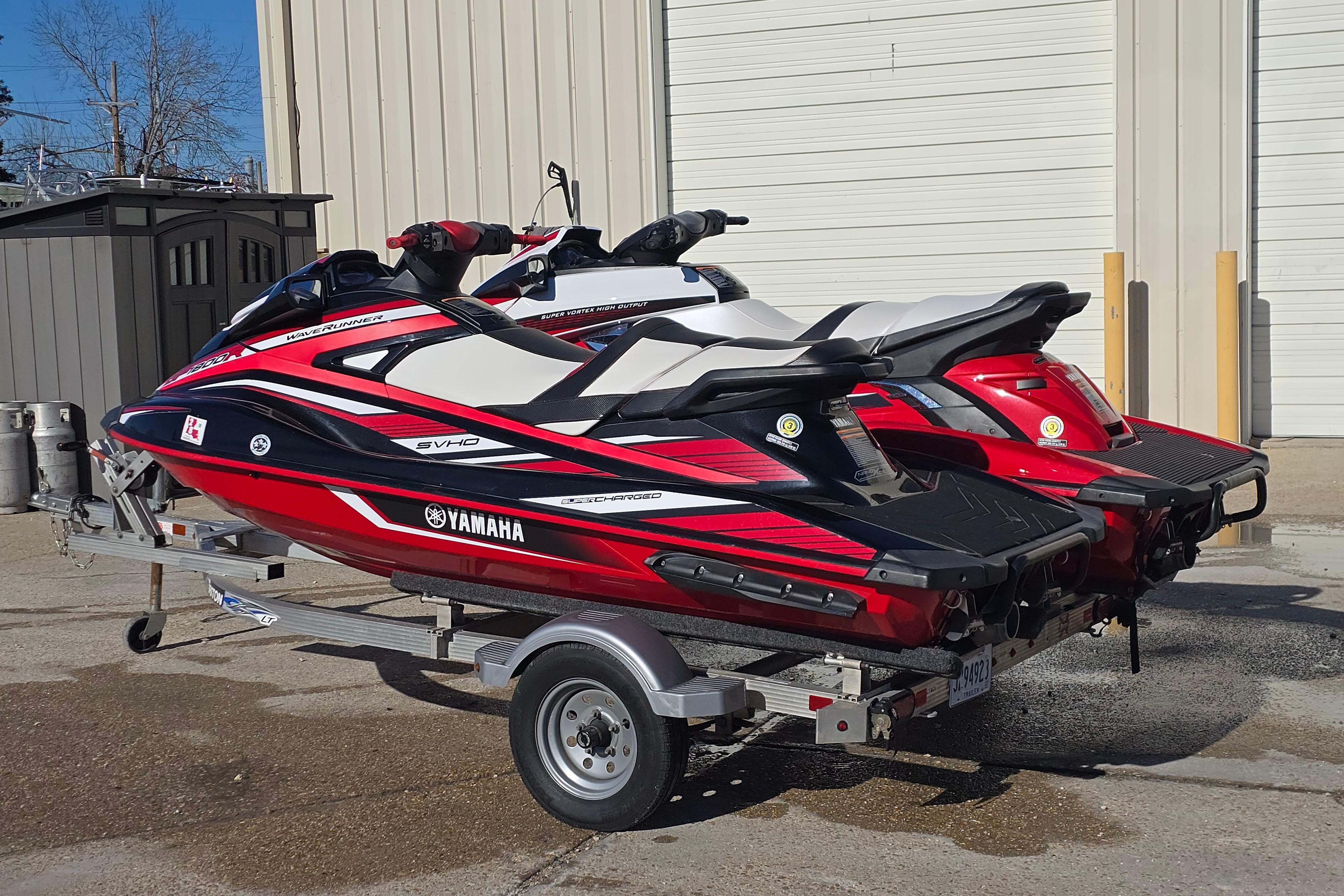 2019 Yamaha WaveRunner GP1800R SVHO jet skis on a trailer, parked outdoors.