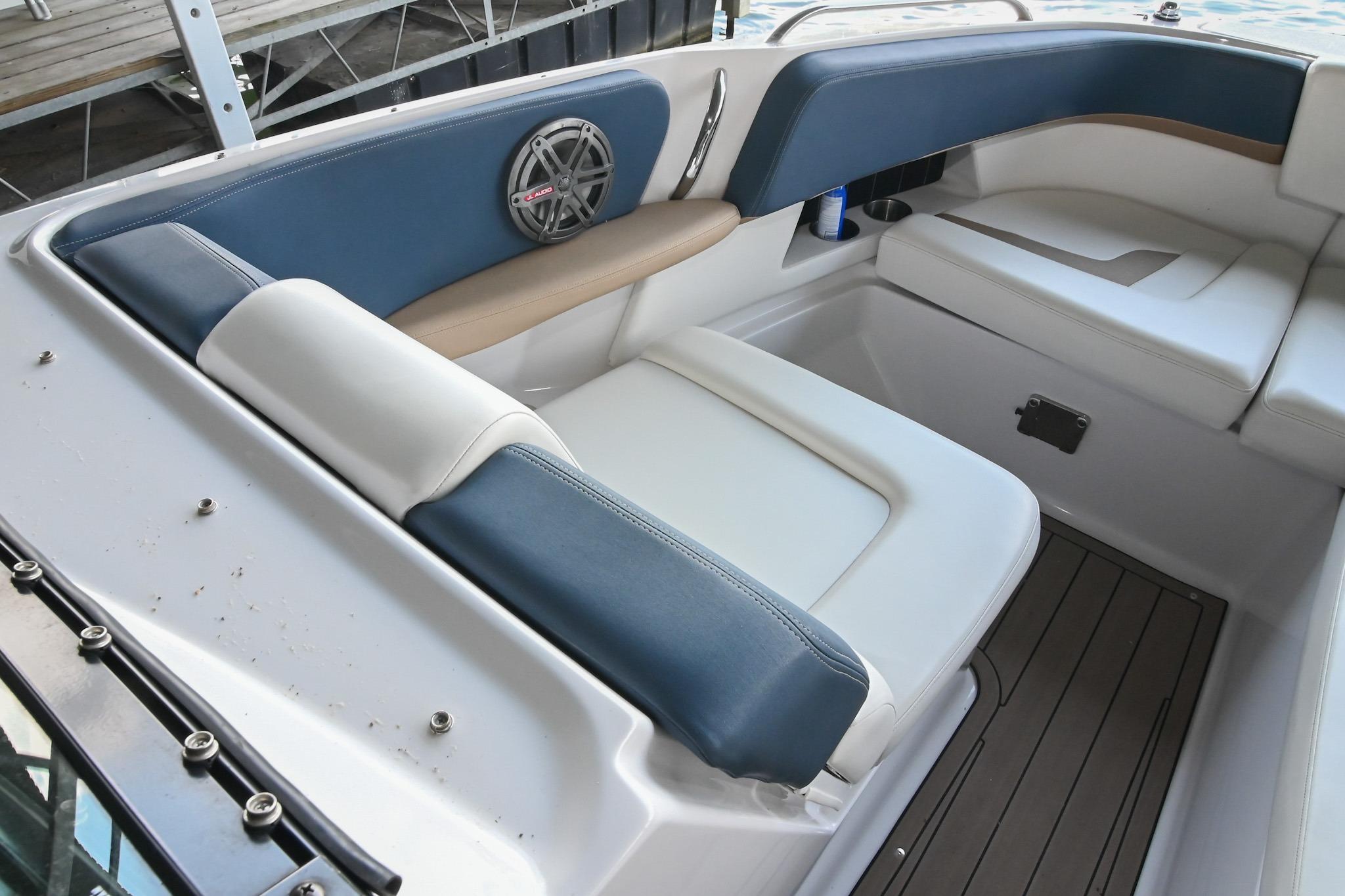 Interior seating of 2014 Four Winns H290 boat with blue and white upholstery.