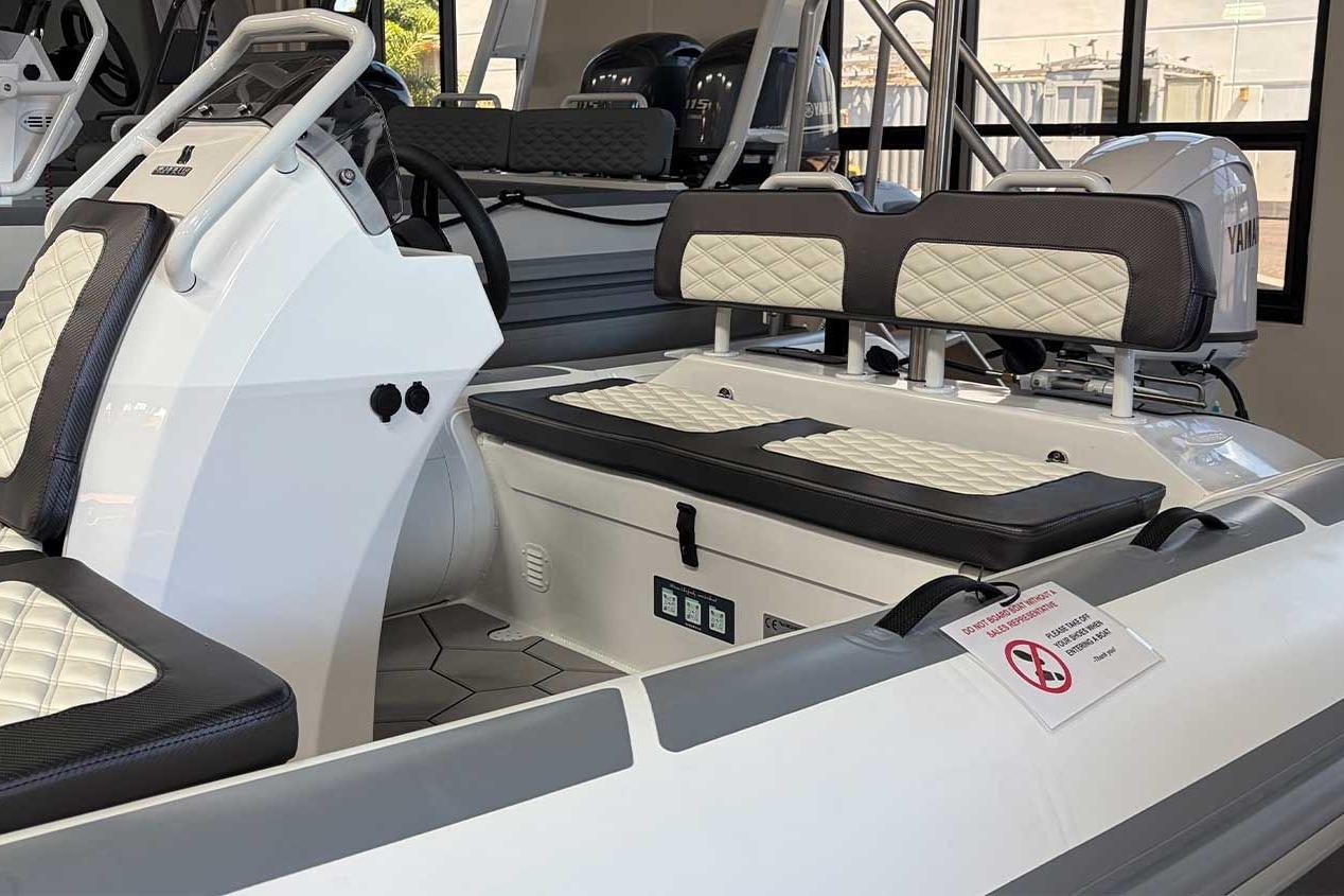2026 Highfield Sport 460 boat interior with cushioned seating and modern dashboard design.