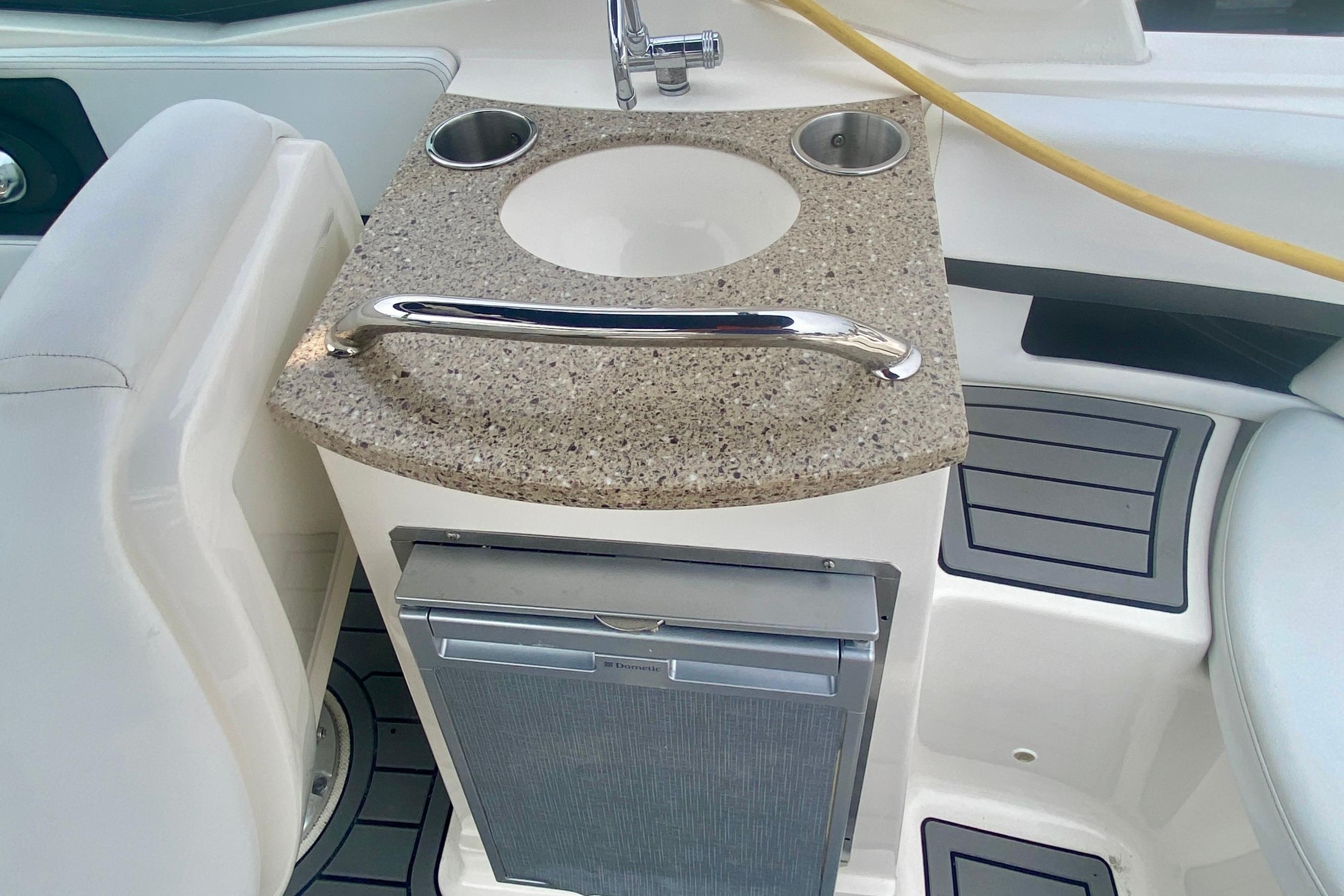 2015 Sea Ray 250 SLX boat interior with sink and mini fridge.